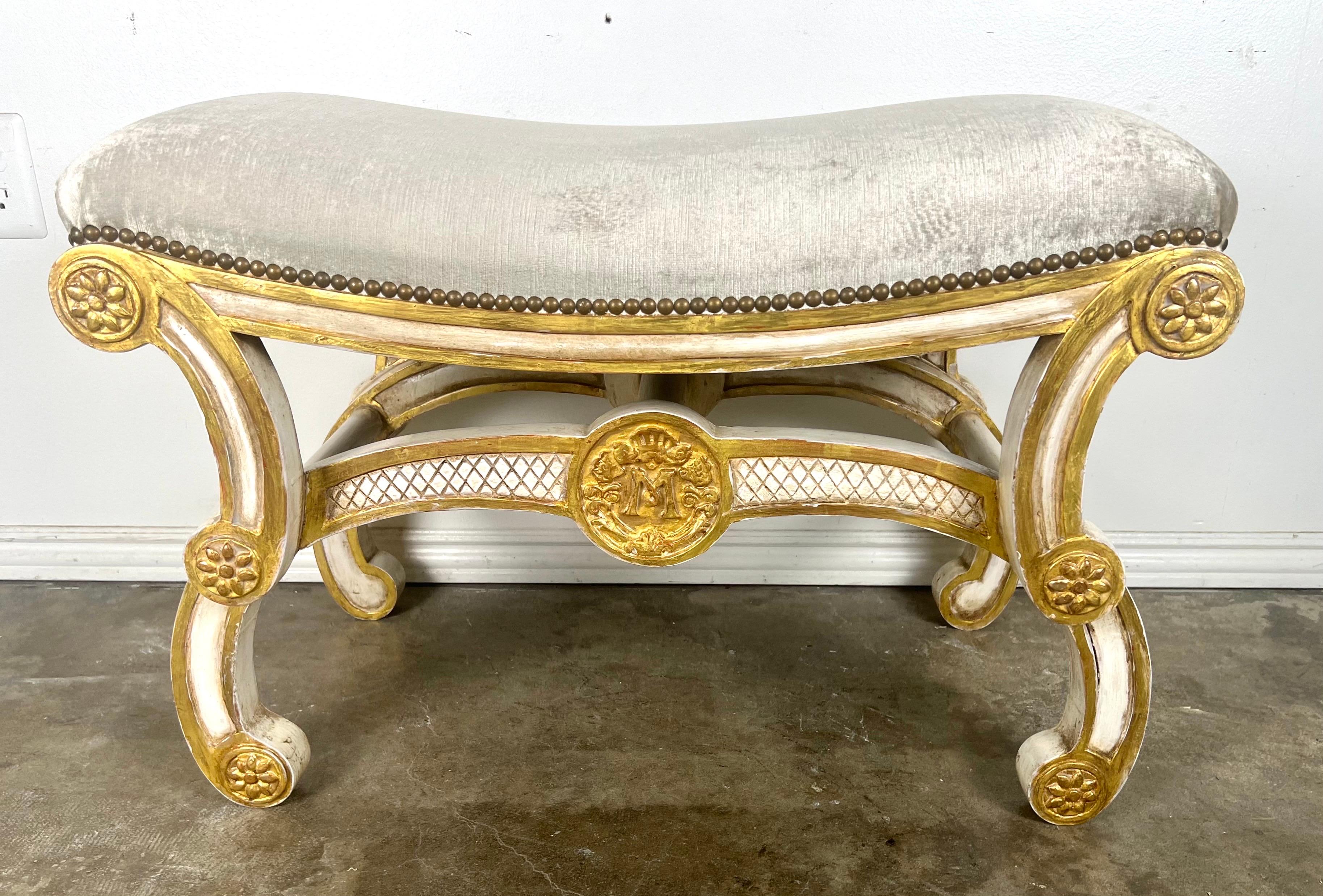 This Rococo Italian style bench beautifully captures the opulent and decorative essence of the Rococo period.  It features painted and parcel gilt embellishments that enhance its elegance and visual appeal.  The scrolled legs are a classic Rococo