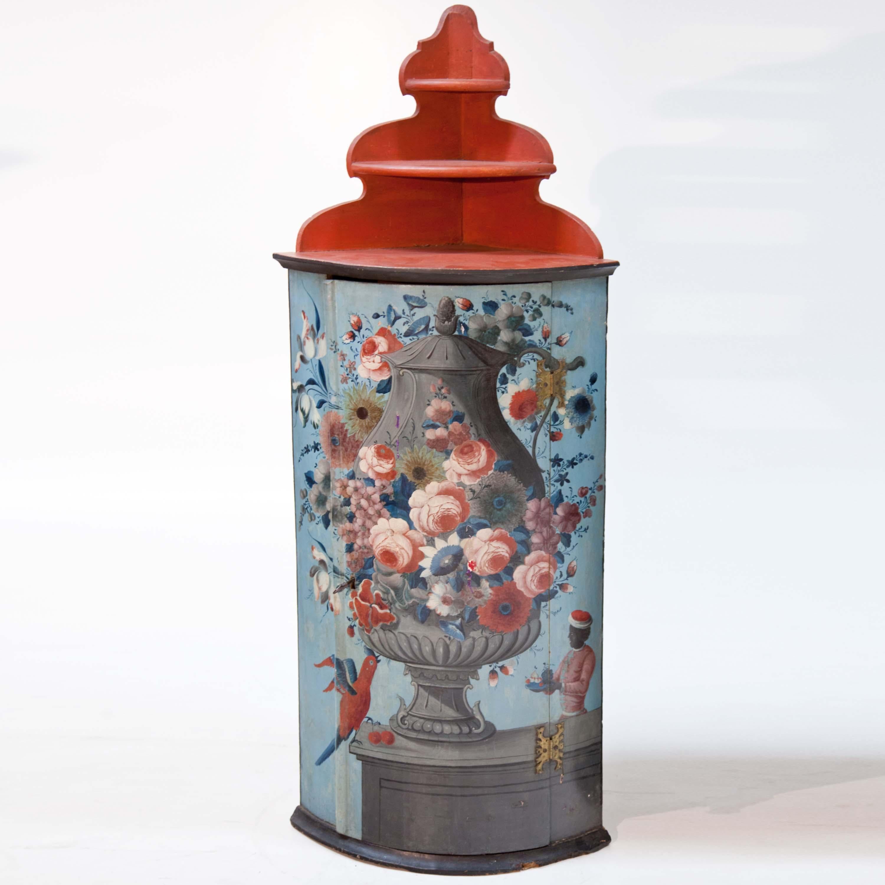 Small corner cupboard in Italian style with polychrome amphora with flowers on the front. The segment-shaped body (side length 33.5 cm) is complemented by a red three-tier shelf with a cut-out back wall.