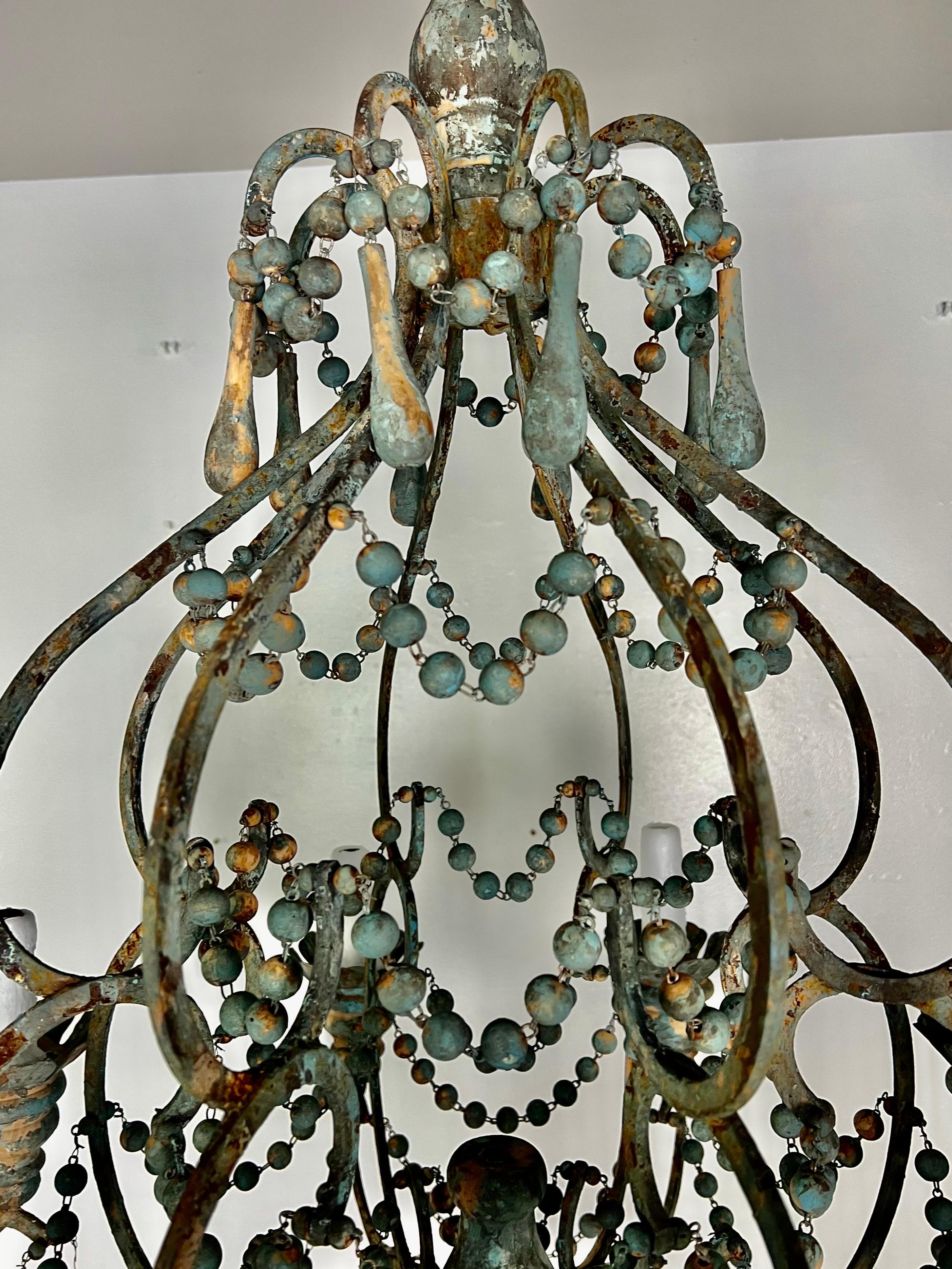 Italian Style Wood and Iron Chandelier with Wood Drops In Distressed Condition For Sale In Los Angeles, CA