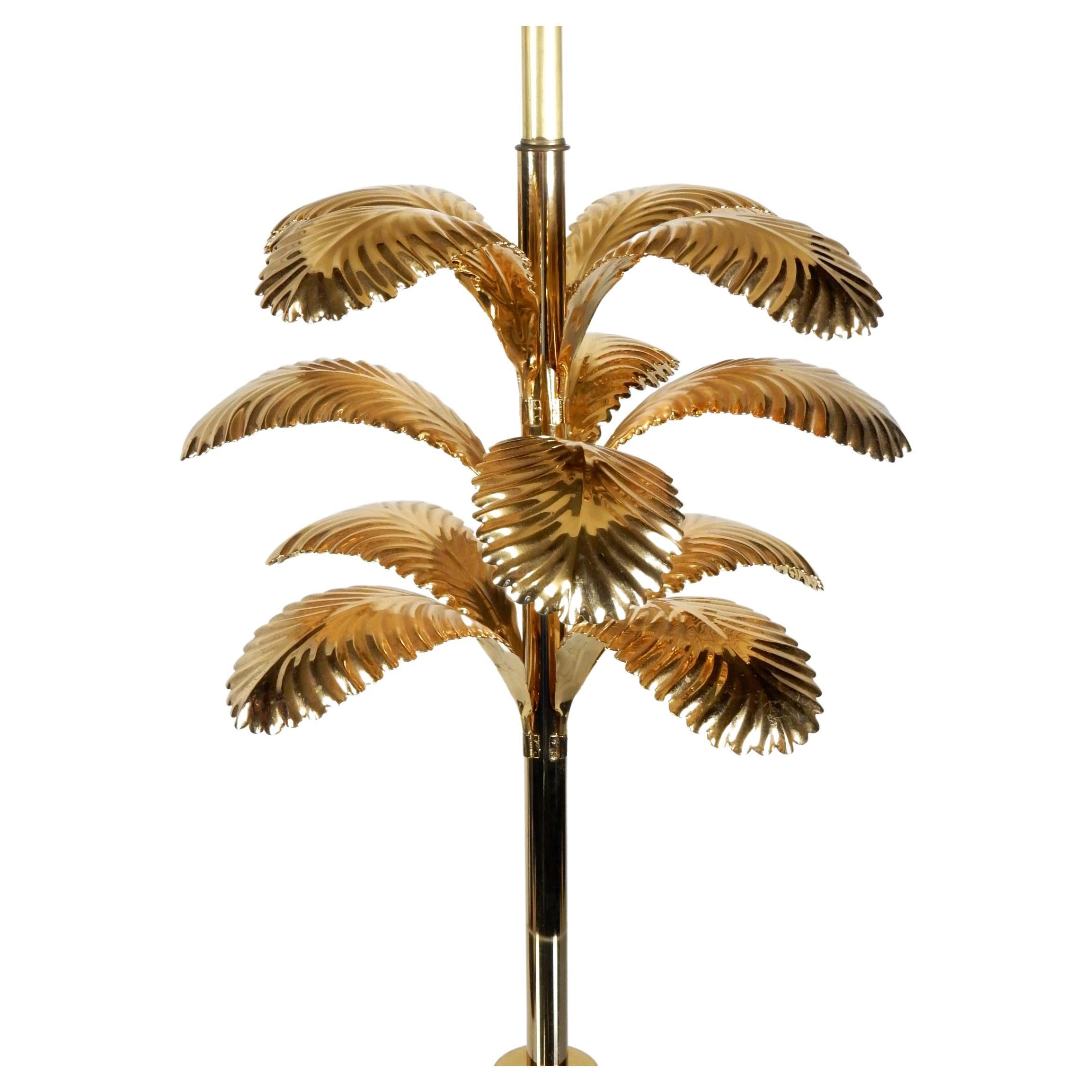 Spectacular brass palm leaf floor lamp/table.
20in Round glass table top stands 26in off floor. 
Weighted tulip brass base keeps it stable.
The brass palm leafs upper section make this a unique
piece of functional art.
2 Standard size light