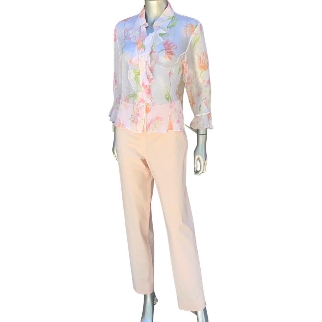 A beautiful blouse and trouser set by Italian brand Leggiardo. The blouse is made of the finest sheer silk fabric in a soft blush, pink ans light green floral print. the blouse is also accented with metallic silver in the print. Ruffle trim on front