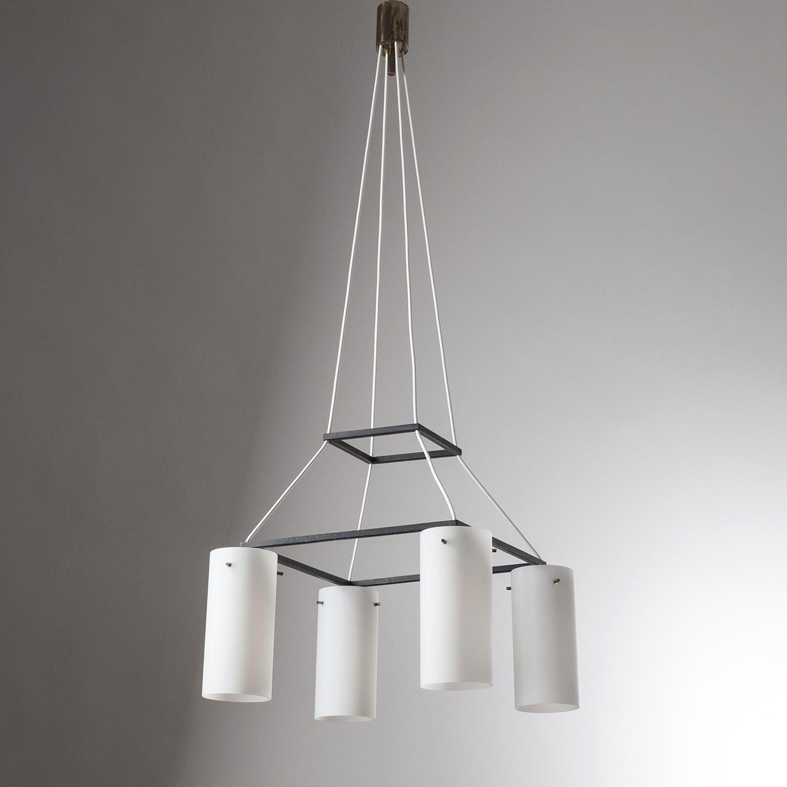 Rare Italian modernist suspension chandelier from the 1950s, attributed to Stilnovo. Four satin glass diffusers hang from a black lacquered square frame with a smaller square floating above (position adjustable). Original brass E27 sockets with new