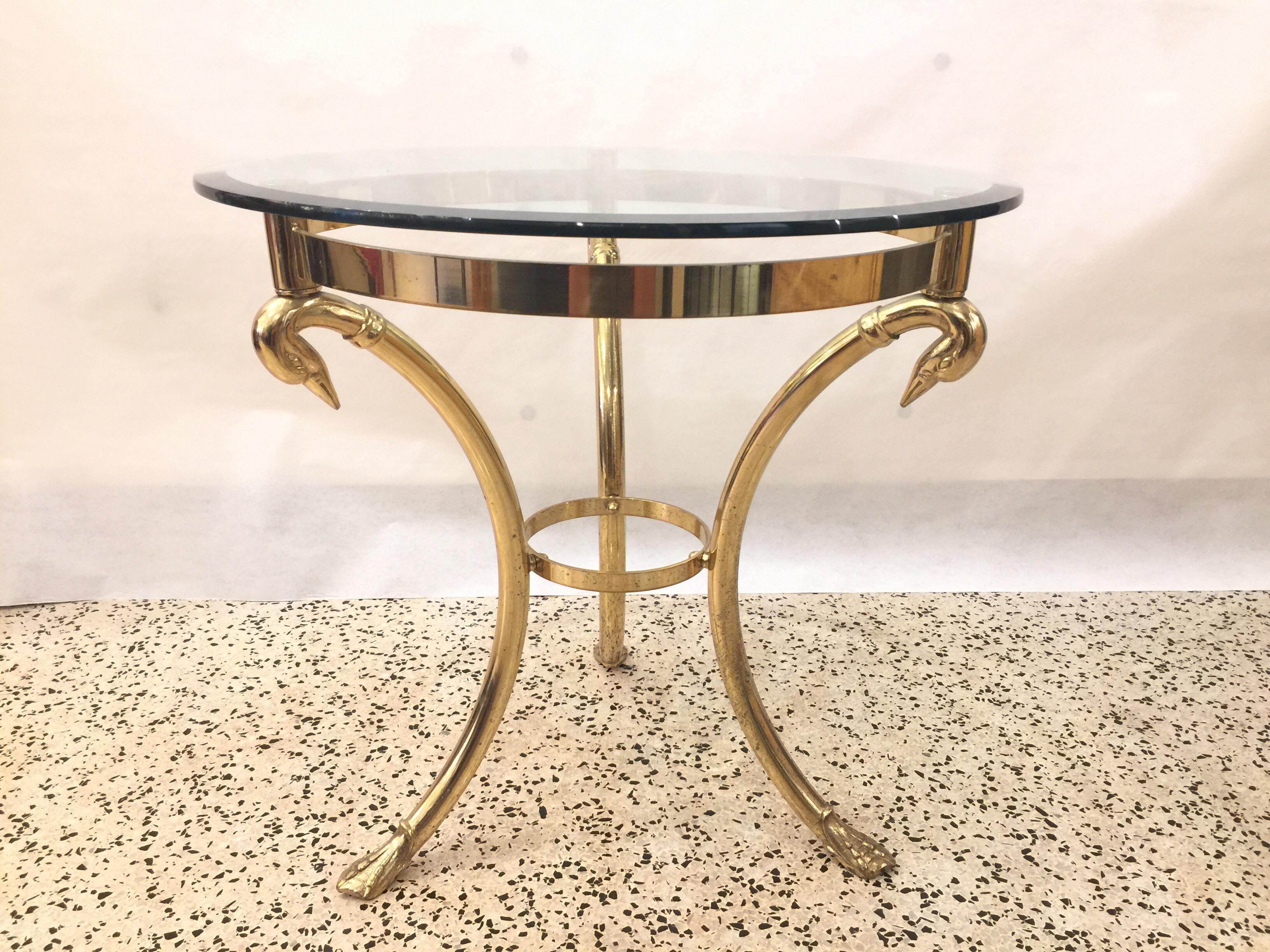 Three-legged Italian brass table with draped swan head supports and swan feet- Beveled glass top.