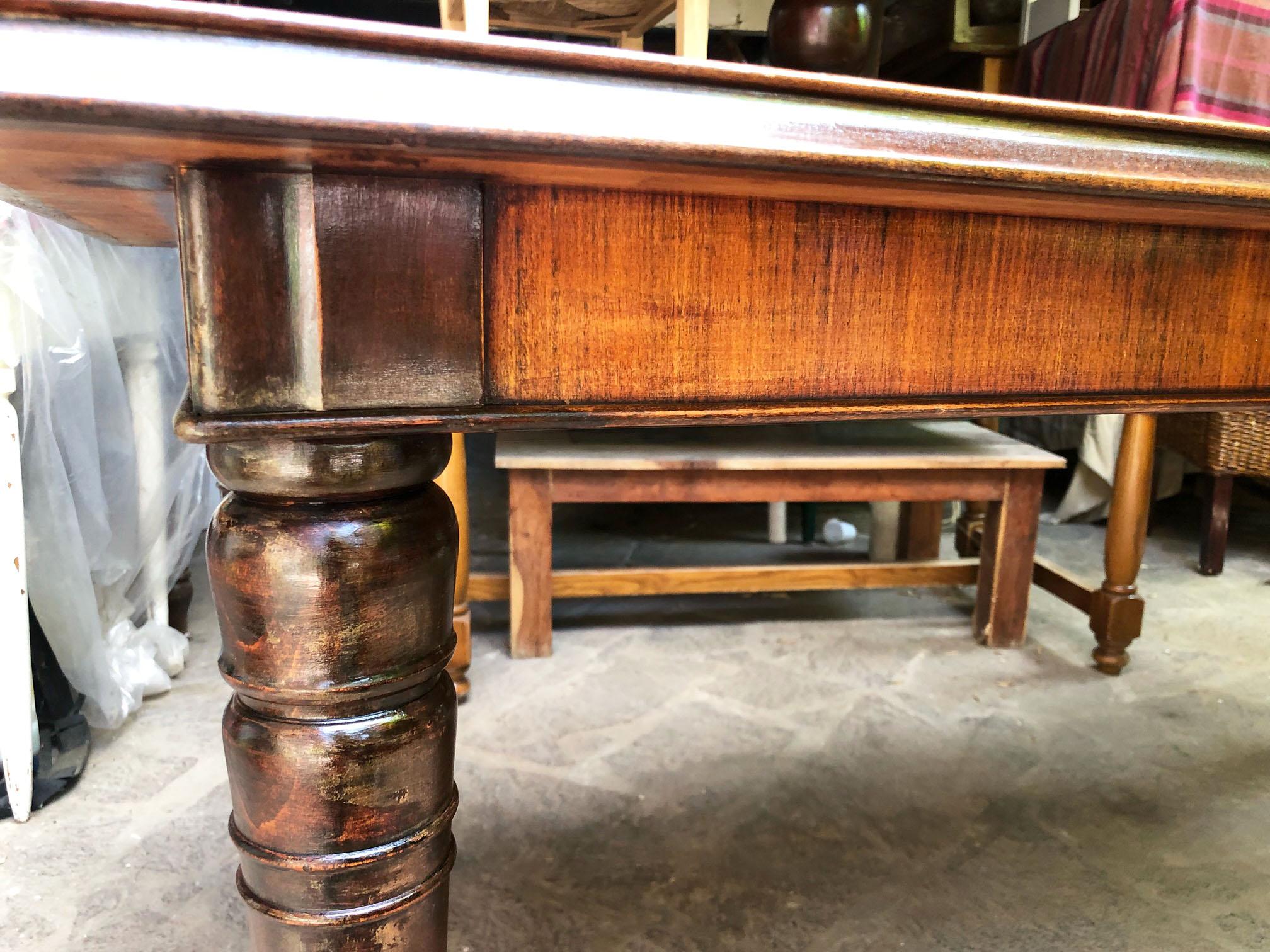 Italian table from 1960, original in walnut, with turned leg, brown glass top with gold-colored decorations.
The table is original in all its parts.
The useful height from the ground to under the perimeter band is 68cm. 
The total height is 79