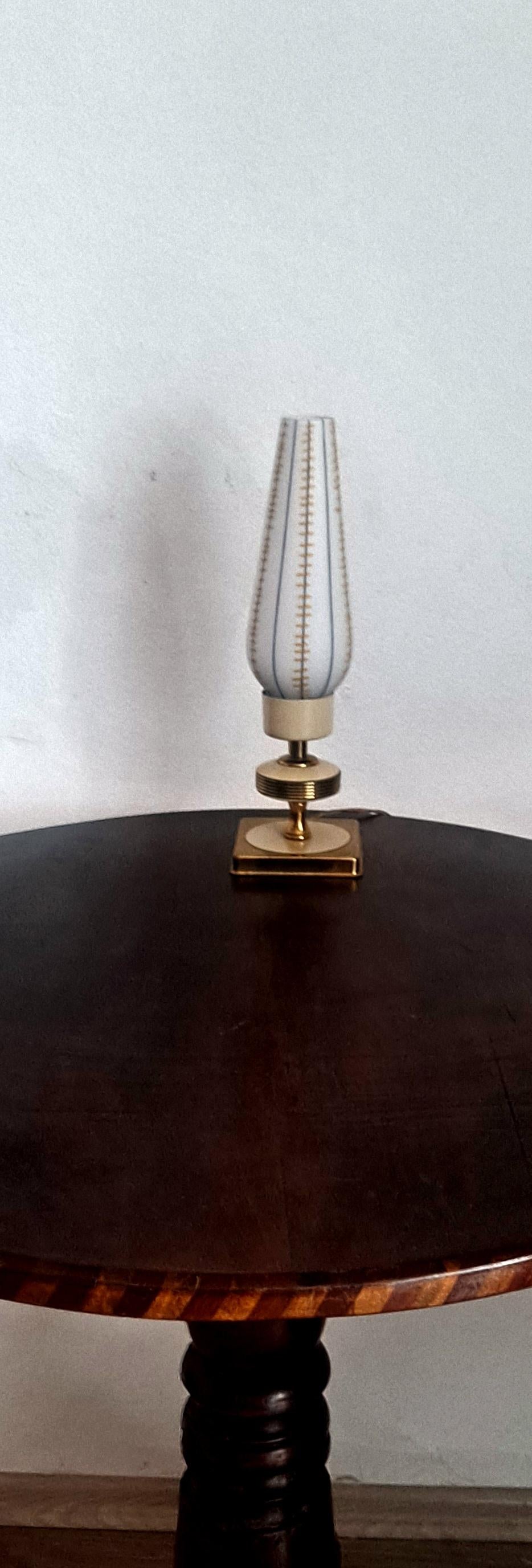Table lamp from the 1950 s. Brass base and Murano ribbed glass.
glass shade produce plenty of good light in the room. 