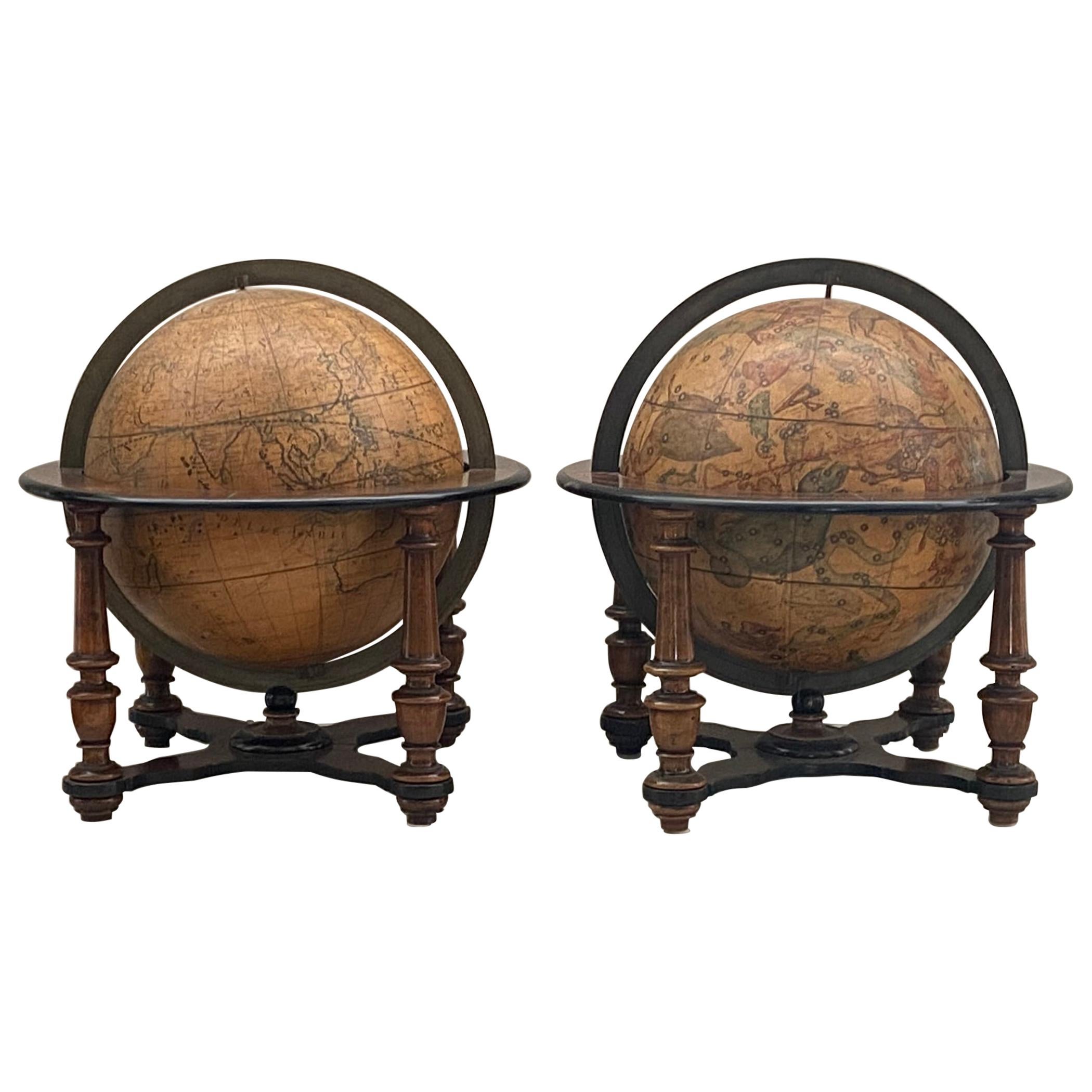 A matched pair of Italian Table Globes after Cassini circa mid 19th century. The globes are comprised of twelve gores and two polar calottes. approximately 20 inches high with an 18 inch diameter.