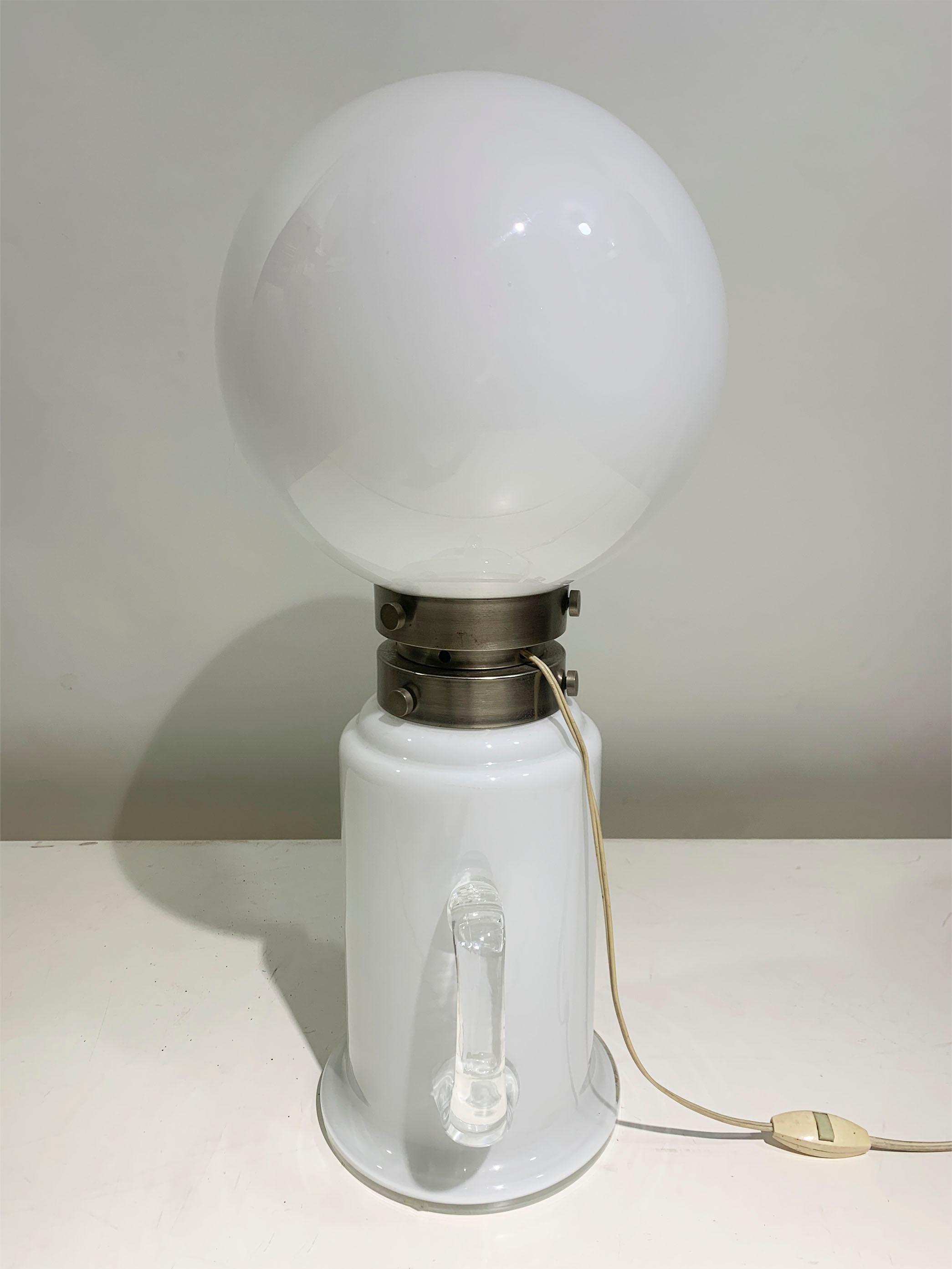 Table lamp by Aldo Nason, with 2 light sources, made from double-layer Murano blown glass, can be used as a table lamp or floor lamp. 

This version with a handle is unique of its sort.  
Chord length: 110 cm/43.3 in


It is currently wired to 220V