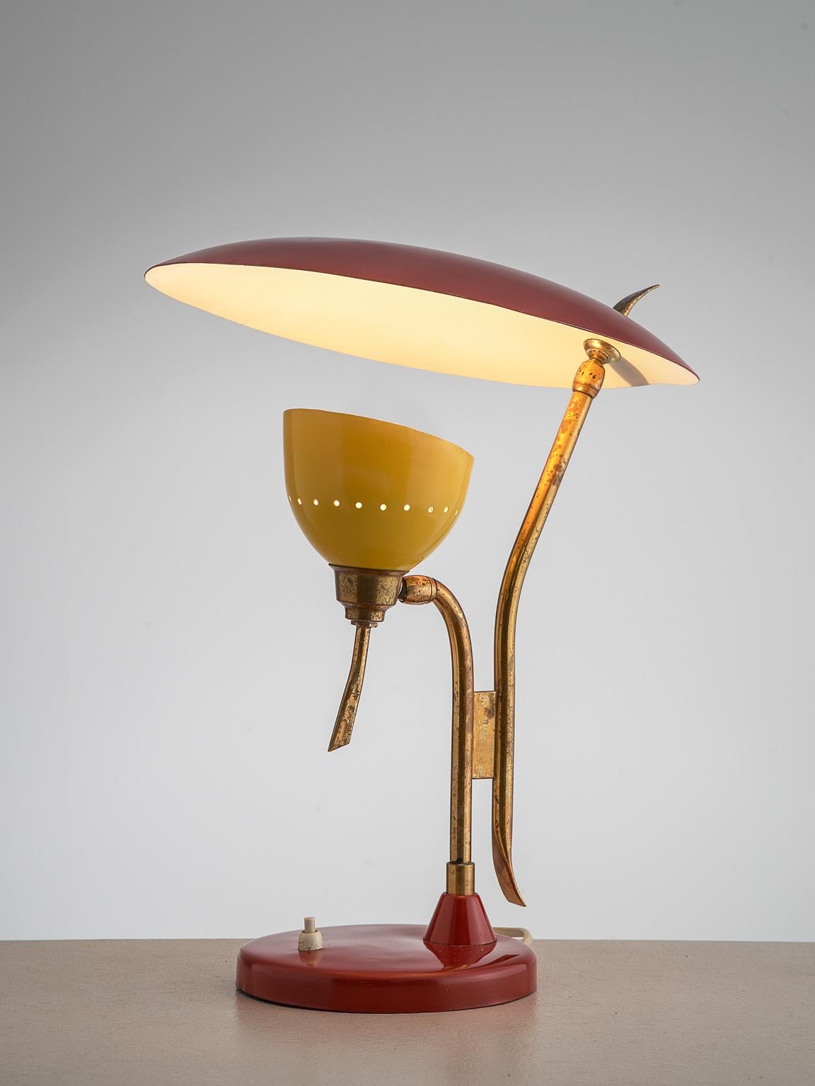 Lumen, table lamp, red and yellow metal and brass, Italy, 1950s.

This 1950s adjustable red with yellow light is manufactured by Lumen. The metal shade holding the lamp is directed upwards to another shade. This creates a beautiful diffuse light.