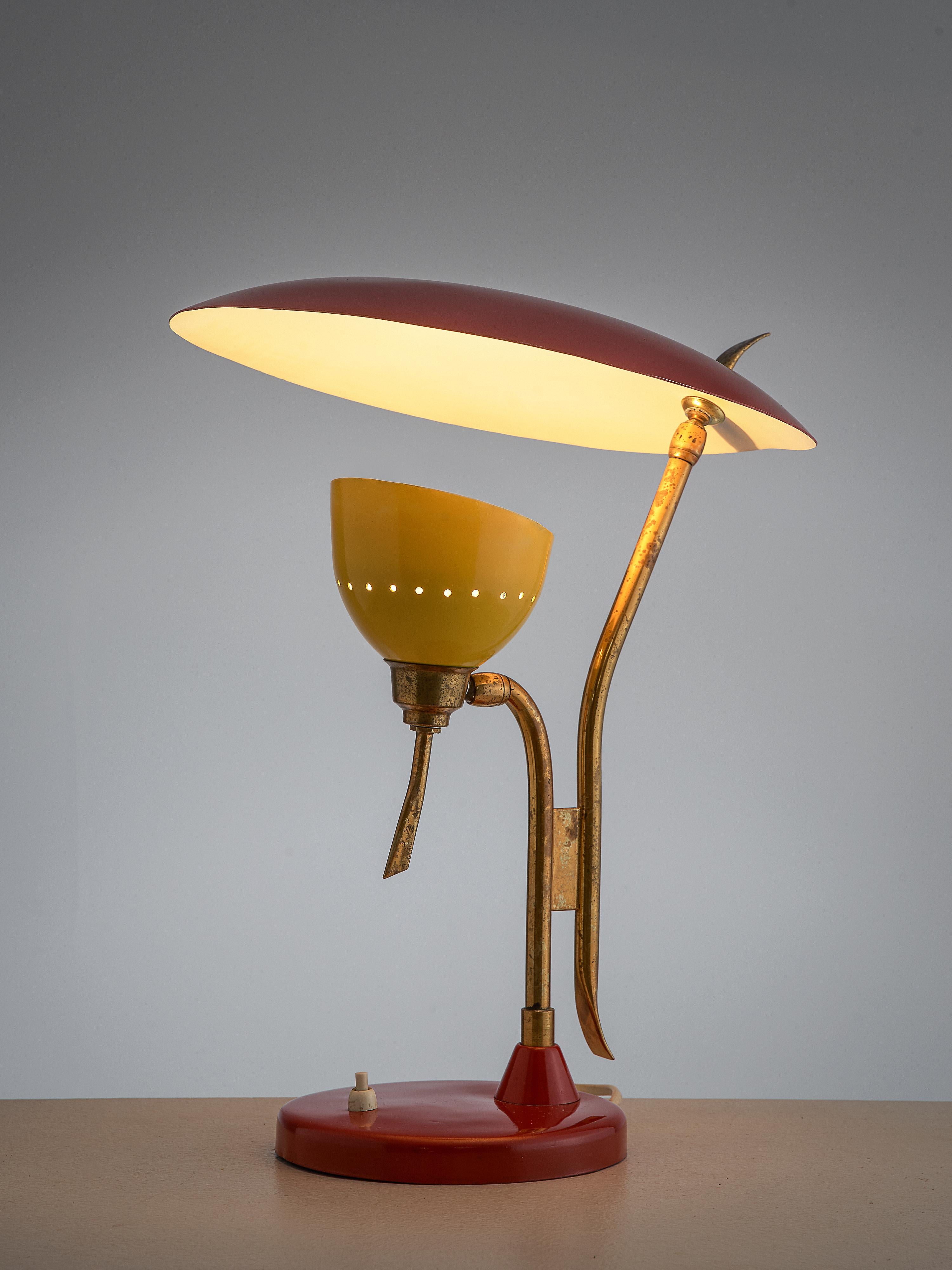 Lumen, table lamp, red and yellow metal, brass, Italy, 1950s

This colorful desk lamp convinces the eye through its well-balanced, organic design. Two shades rest on two brass stems. On the round base in red color a switch can be found. One small