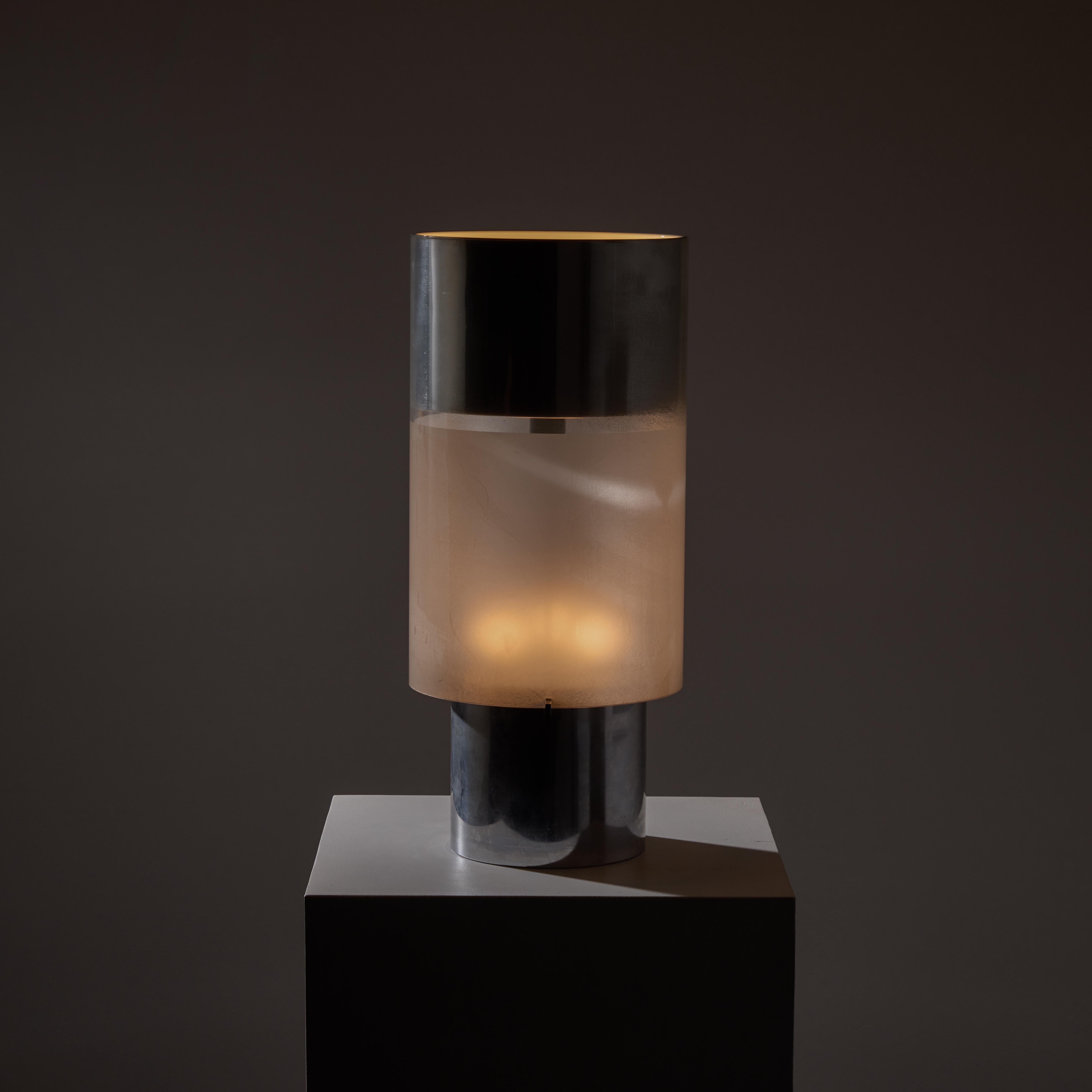 Model D770 table lamp by Candle. A two-way cylinder table lamp comprising of a lower tri socket-type main body, followed by an upper single socket open uplight. Each light can be controlled individually on the dual switch. The finish is a polished