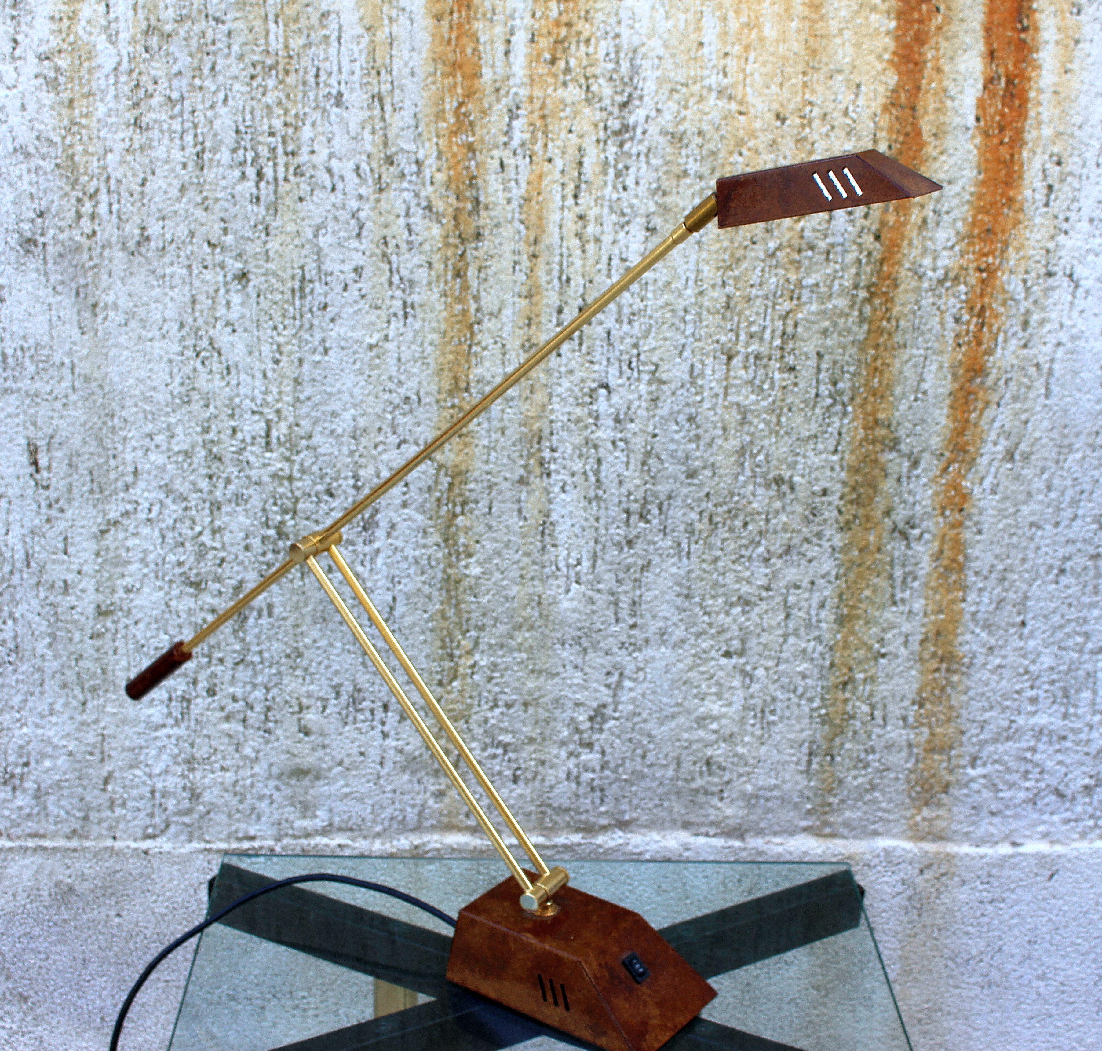 Italian 1970s brass table lamp, adjustable height and pivoting shade. Dimension is adjustable so height is 28 inches max, and 14 min. Depth 29 inches max and 16 min.
