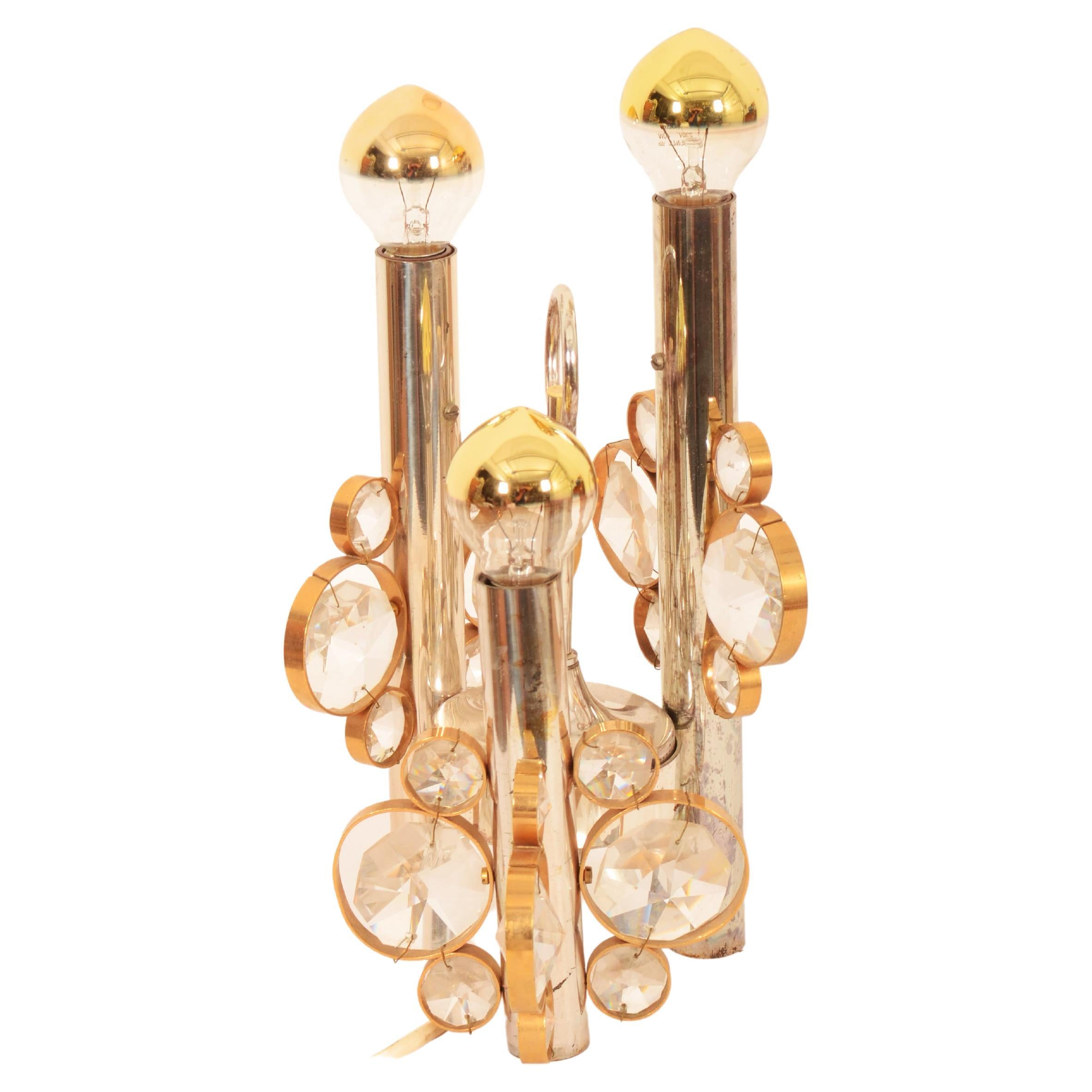 Brass base with glass elements fitted with three E14 sockets. Made in Italy in the 1970s.
