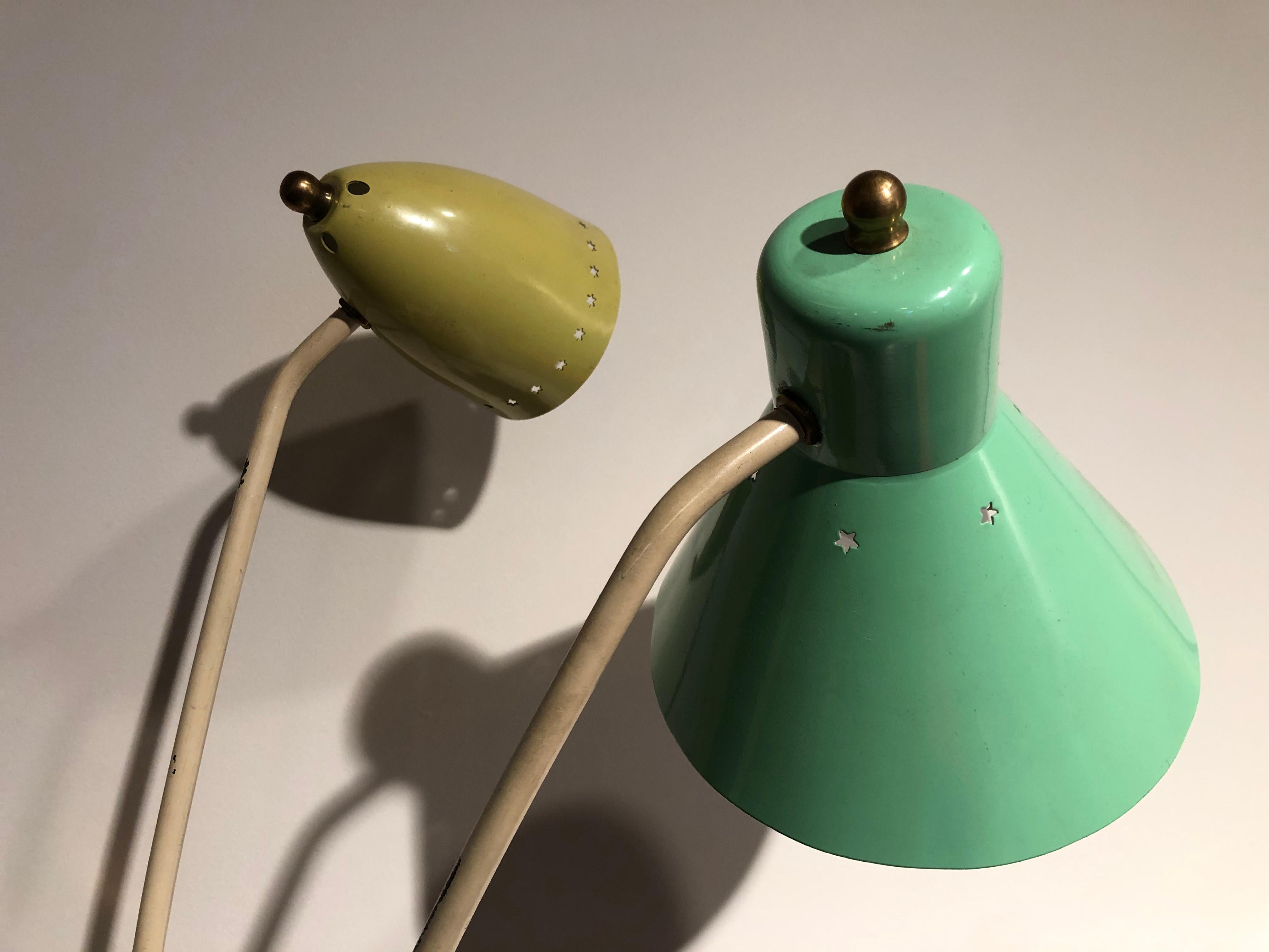 Italian style table lamp with 2 articulated arms 
The 2 lamps shades are in good condition with a not original but old painting (green and yellow)
The 2 electric bulbs are with different size.