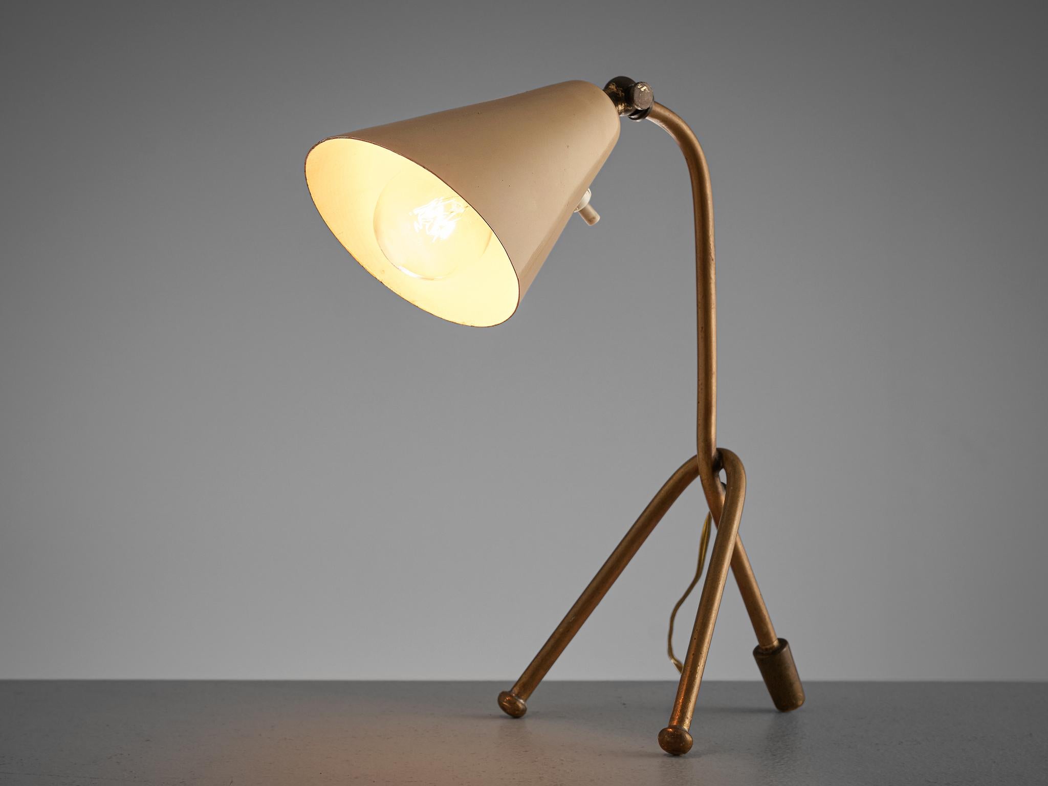 Desk light, metal and brass, Italy, 1960s

Italian table lamp with tripod base. The lamp features a gold brass base and a beige stem which is colored white in the inside. The shade can be positioned in different direction, which makes it very