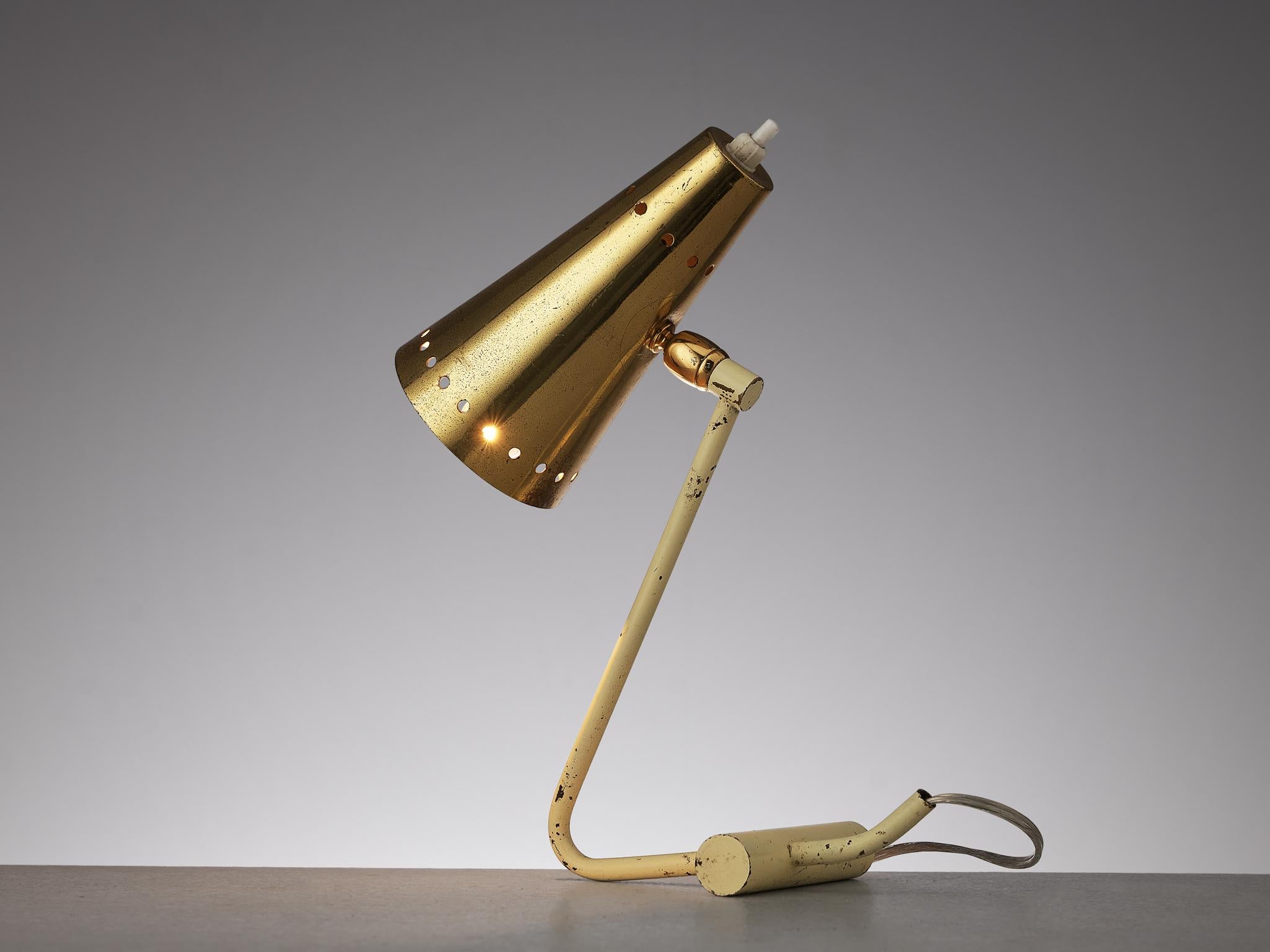 Table lamp, brass, metal, Italy, 1960s.

This table desk lamp is stunningly executed in brass and metal. It features typical Stilnovo shades with the recognizable holes in the rim of the shade that form a circle. The base of this small, playful