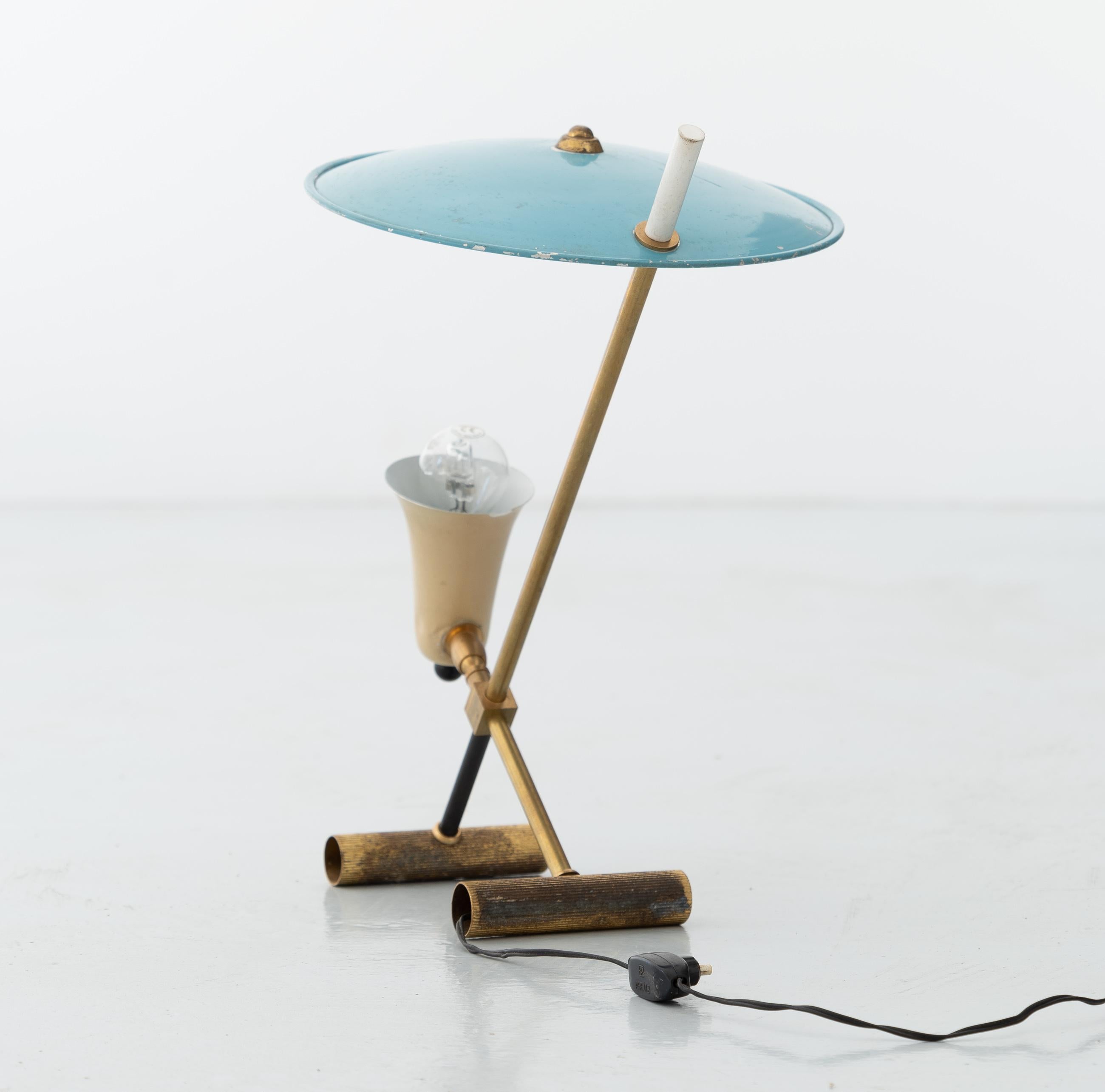 Table lamp, Italy, 1950s, brass, blue and cream enamelled aluminum.

An interesting lamp with a refined design. Original condition, patination and oxidation of the brass parts, small lacks of paint on the lampshade.