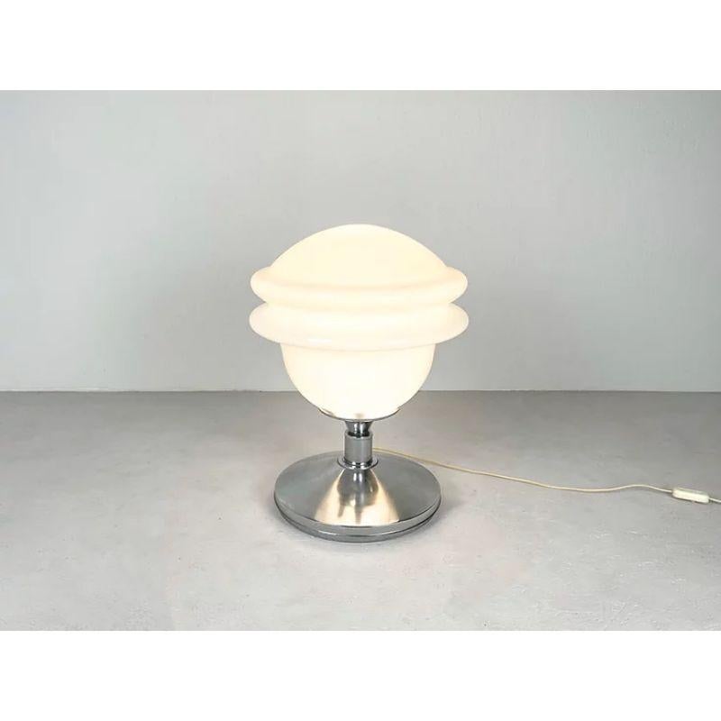 Italian table lamp in opaline glass shade

A beautiful Italian table lamp with a big opaline glass shade which creates a lovely light. Although I can't really put a name on this lamp, it reminds me of Carlo Nason, a well known Italien designer.