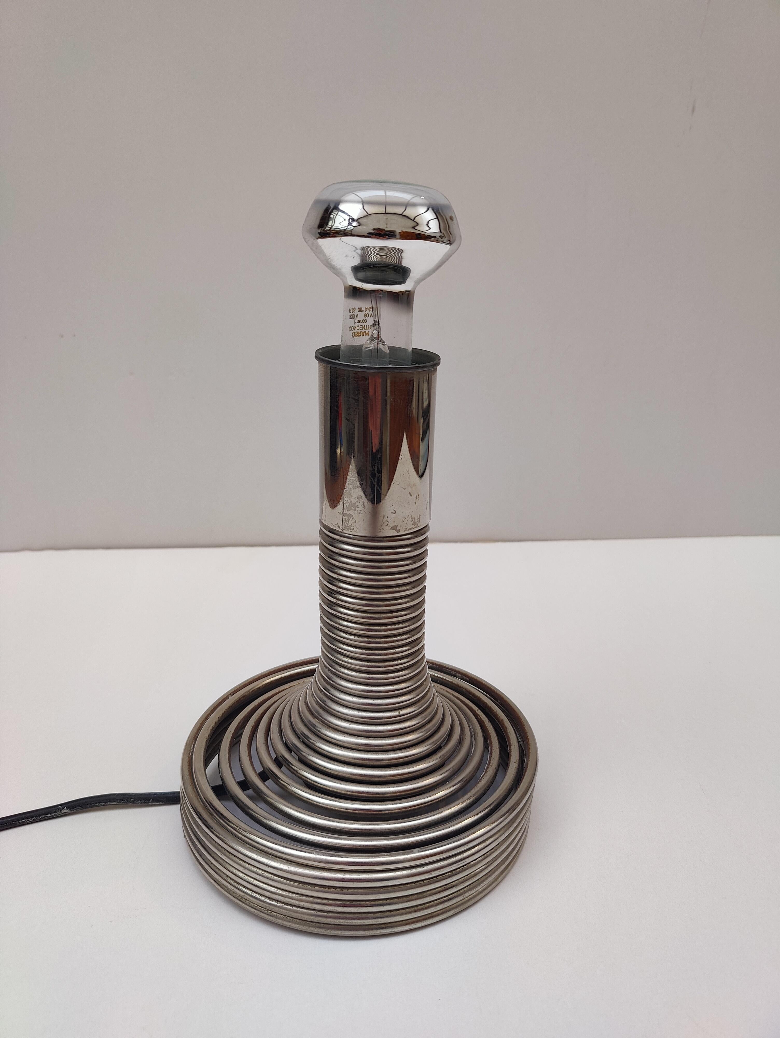 Introducing the Fabulous “Spirale” table lamp by Angelo Mangiarotti, Italy circa 1970, now available for sale. This stunning piece was manufactured in Italy by an unknown maker and features a chromed steel spring with a hidden and integrated switch
