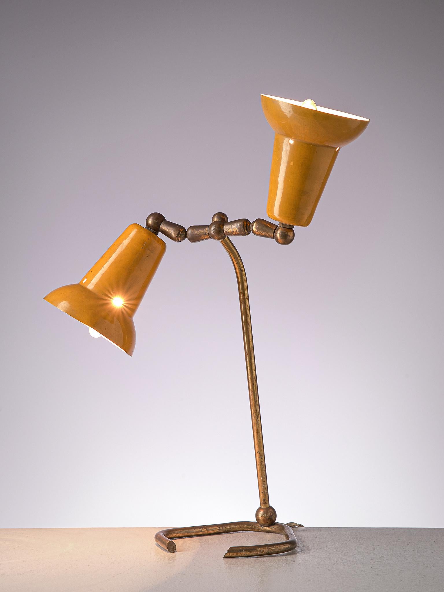 Desk light, metal and brass, Italy, 1960s

Simplistic, yet playful table lamp from Italy. The lamp features a brass, tubular foot and stem, which ends in two arms that each hold one shade. The arms are  The metal shades are lacquered in ochre yellow