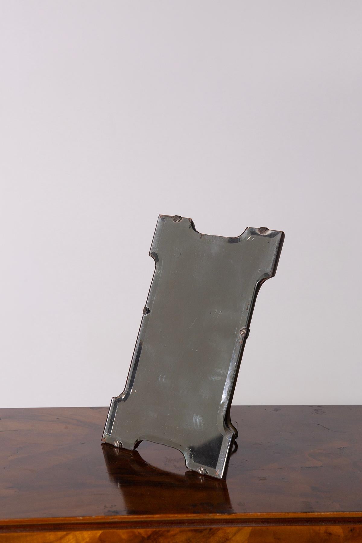 
This exquisite Italian Art Deco table mirror is a fine example of early 20th century craftsmanship that exudes timeless elegance and vintage charm. The mirror's sophisticated design and aged patina tell a story, craftsmanship and exquisite
