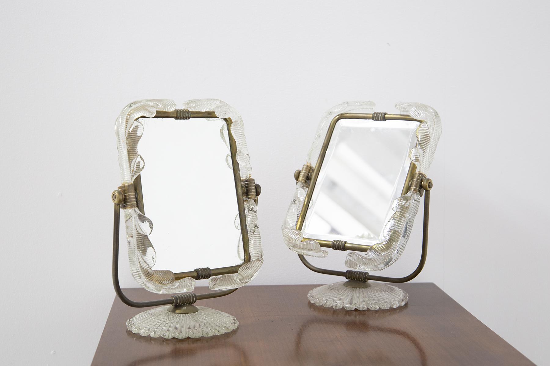 Spectacular pair of 1950's Italian table mirrors made by Barovier and Toso. The pair of mirrors can also serve as vanity mirrors for a makeup desk. The mirrors also have a dual function, if you turn the mirror around on its inner side we find a