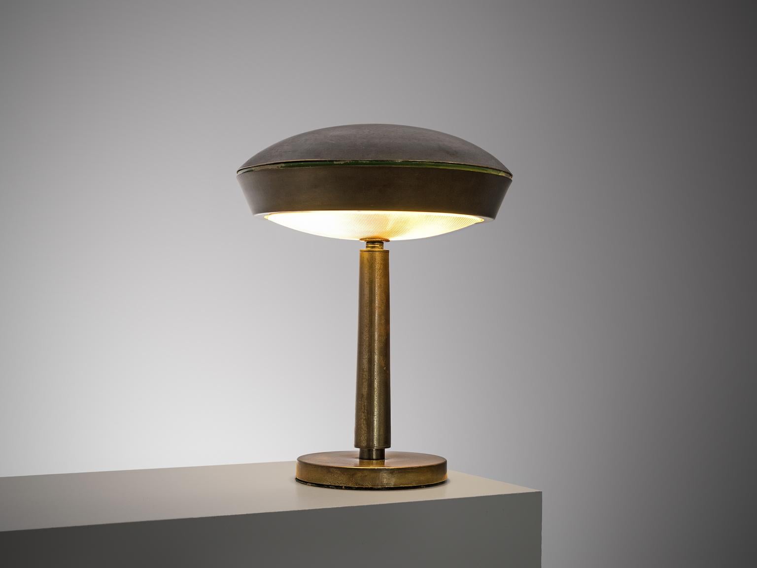 Table lamp attributed to Fontana Arte, brushed brass and glass, Italy, circa 1950 

This desk light has a hidden light source and holds the shape of a mushroom. The stem has a tubular form. With it's circular lines this voluptuous lamp, holds a