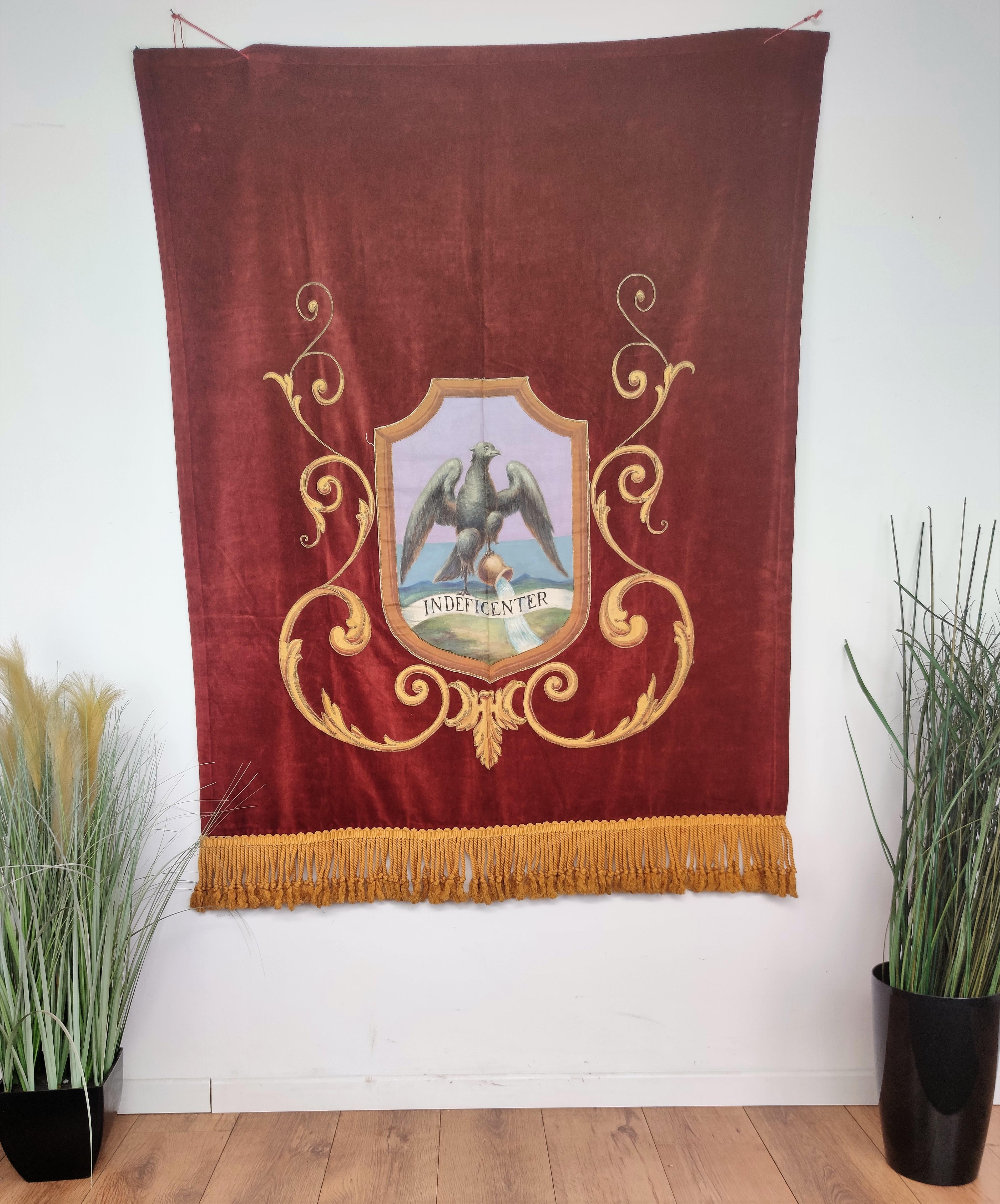 Beautiful Italian fabric tapestry in bordeaux velvet background with hand painted coat of arms representing the city of Fiume symbol with golden thread classic decors on the sides. 

After WW1 the city of Fiume or Rijeka was not assigned either to