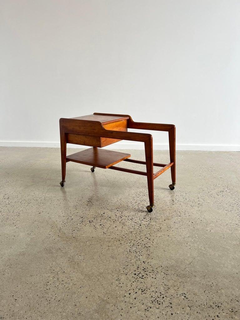 Italian Teak Wood Trolley Bar 1960s.
Very typical design for that era, two storage compartamnet.
One top compartment and one draw at the back of the trolley. 
A small crack next to the draw doesn’t effect the funcioinality of this piece at all.