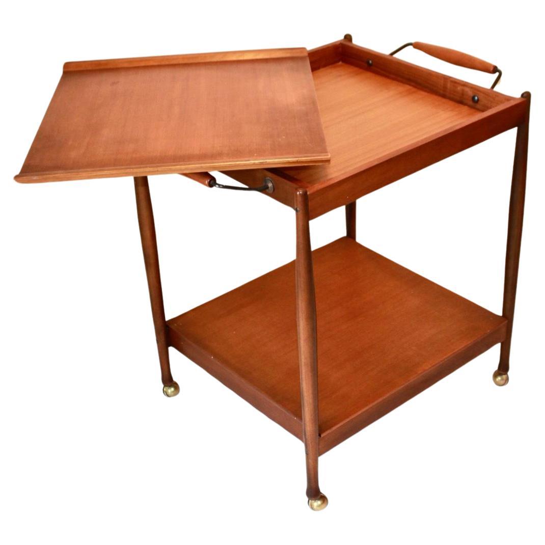 Vintage teak bar cart, Fratelli Reguitti, Italy 1950s

This Vintage Teak Bar Cart, designed by Fratelli Reguitti in the 1950s, is a rare piece of Italian design. Crafted with a teak wood structure, it features elegant brass bars and smooth-rolling