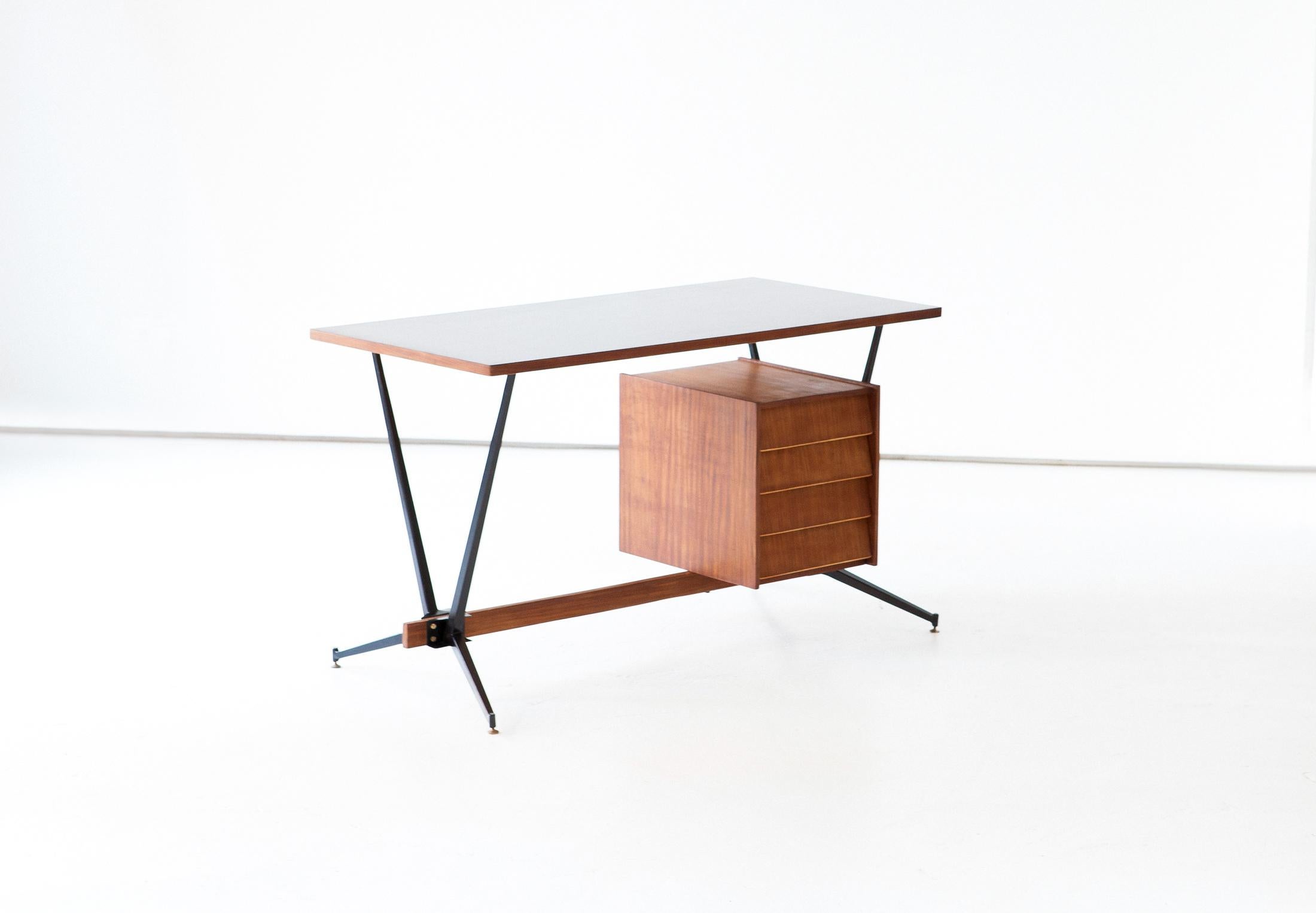 Mid-Century Modern desk, manufactured in Italy in the 1950s,

This table with chest of drawers feature a black enameled iron frame , bruno teak wood veneer, black top and little brass details

completely restored :
Wooden parts sanded and oil