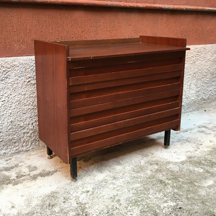 Italian teak, metal and brass chest of drawers, 1960s. Teak chest of drawers with tray top and four drawers, metal legs and brass tips.