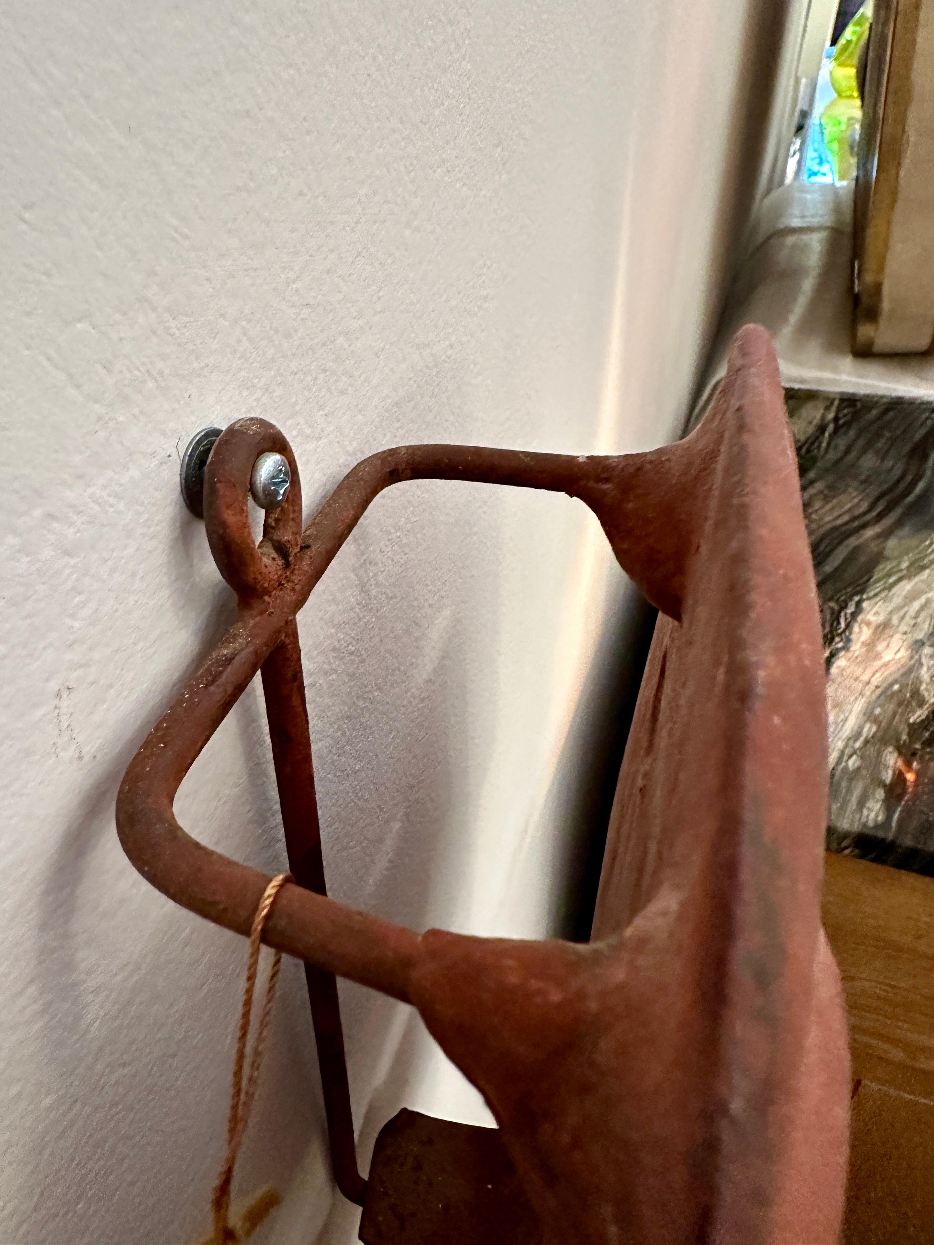 Primitive style sculptural clay mask candle sconce made in Italy. Hand made in an aged adobe color with a place for a single candle inside. Mask has a metal frame which gives the piece a nice depth from the wall and provides a surface for the candle