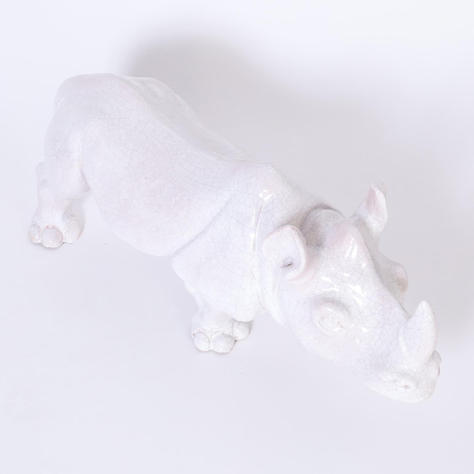 Mid century rhinoceros sculpture crafted in terra cotta with a white crackle glaze.