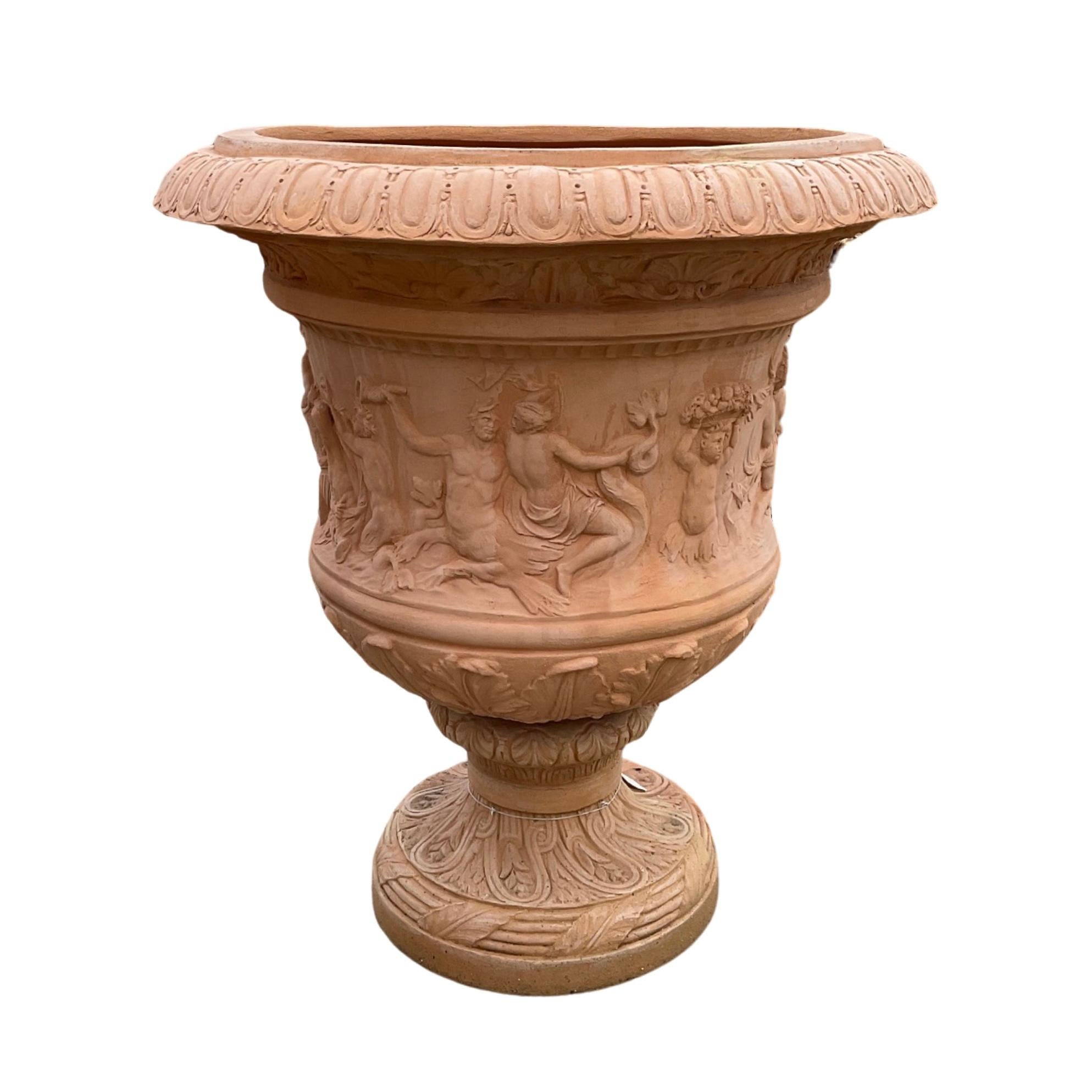 Expertly crafted in Italy, this midcentury terracotta planter boasts intricate Greek carvings of Gods. Its large size is perfect for showcasing beautiful plants and adding a touch of ancient elegance to any space. Elevate your gardening game with