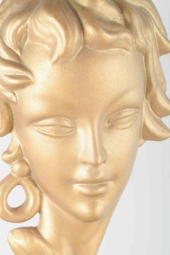 Italian terracotta wall relief depicting a female head, 1950s.