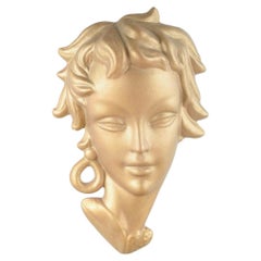Italian terracotta wall relief depicting a female head, 1950s.