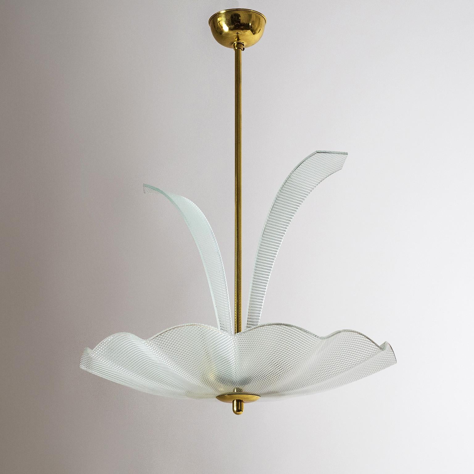 Unique Italian textured glass and brass chandelier from the 1950s. Very unusual mix of playful lyrical design with modernist geometrically textured glass. The glass elements also have a very fine gold paint rim applied to them which is slightly worn