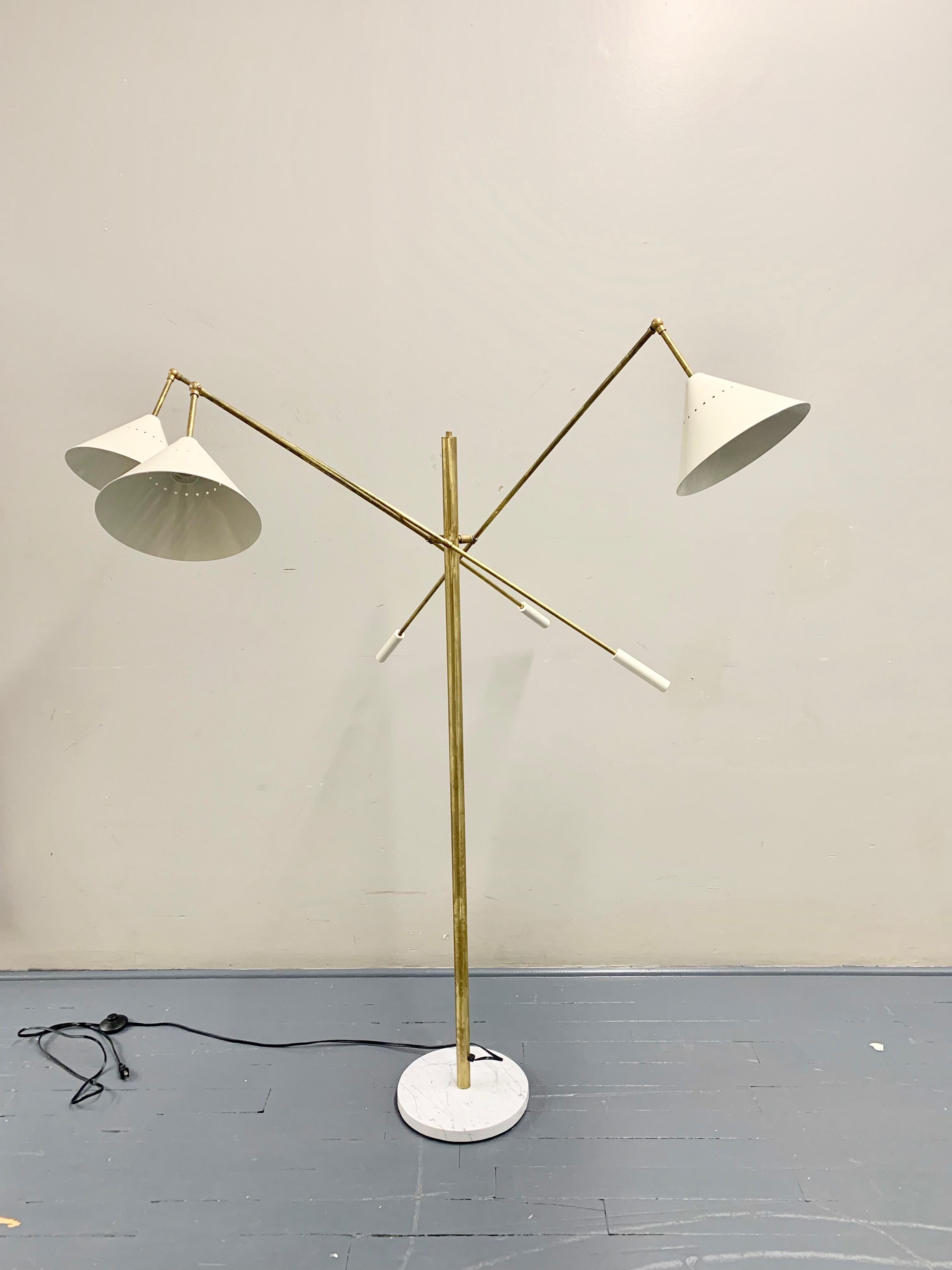 Italian midcentury style floor lamp adjustable three-arm lamp ‘Triennale’ style. Conical shades white, Carrara marble base, arms and body made of solid brass and hand wax painted. Each arm features counter weights of the same color of the shades.
