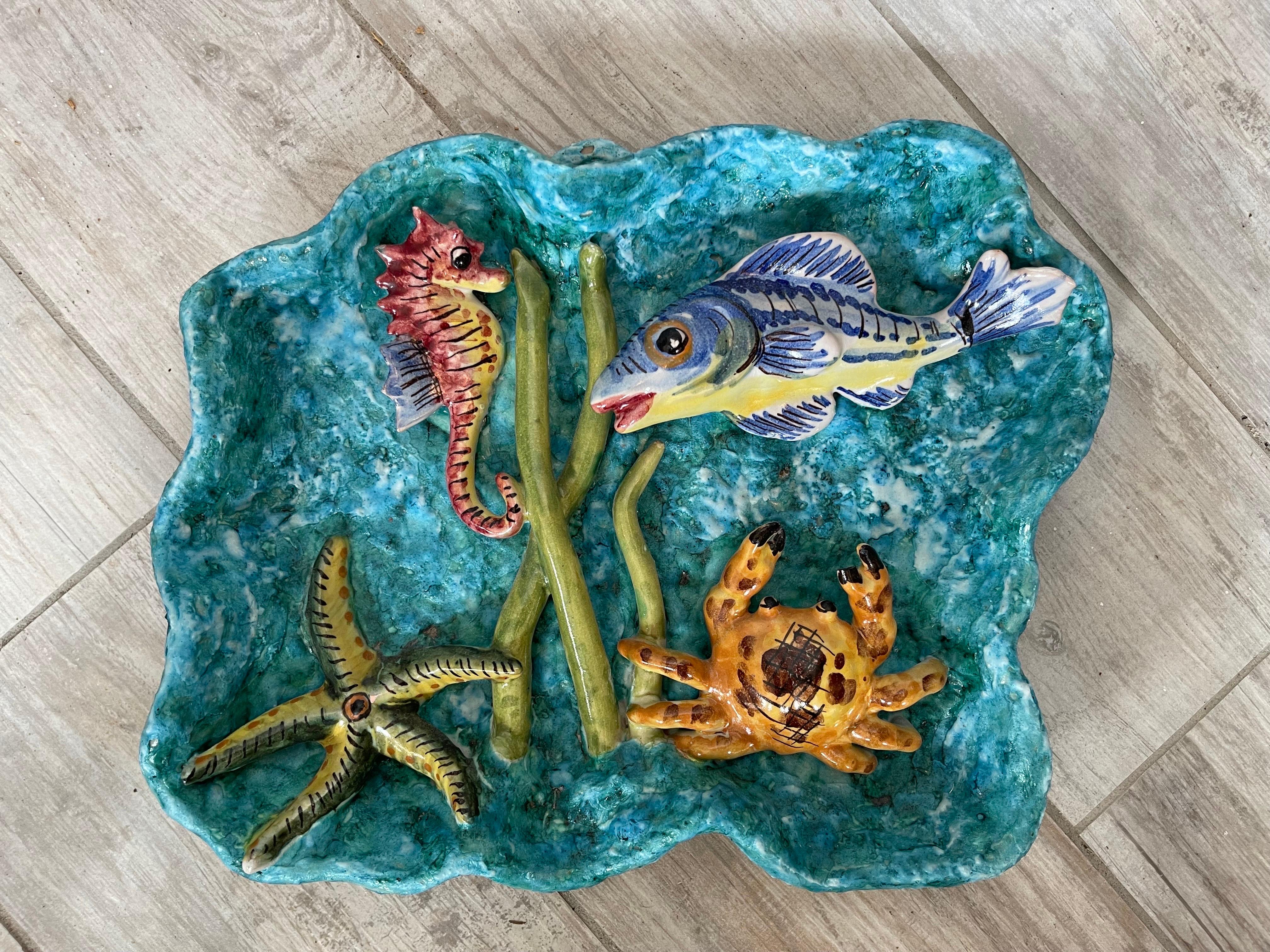 Vintage glazed terra cotta platter with three dimensional SeaLife. Very whimsical & colorful.