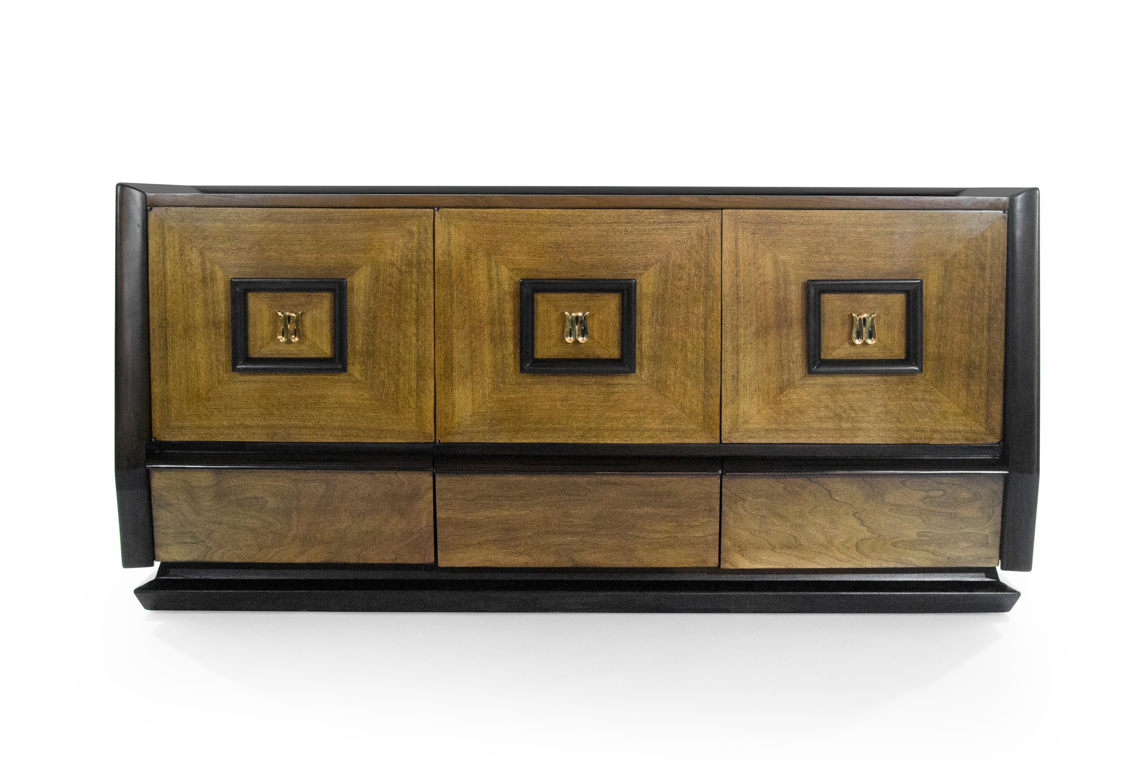 A very chic dual tone credenza original from Italy, 1940-1949. Case has been expertly restored, each door opens up to reveal a set of large drawers providing ample storage space with an additional three drawers at the bottom. W-Shaped brass hardware