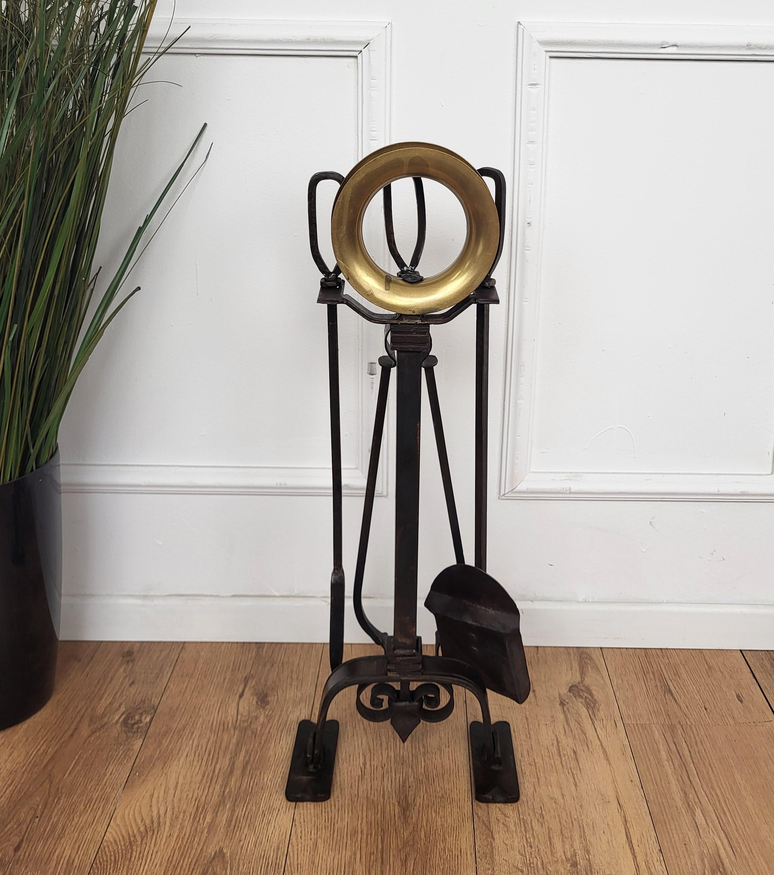 Beautiful Italian brass and wrought iron three-piece fire tool set with stand. The set consists of a poker, a shovel and a pair of tongs, each with an ornate handle such as the stand in beautiful circle shaped brass decor detail.
We do have