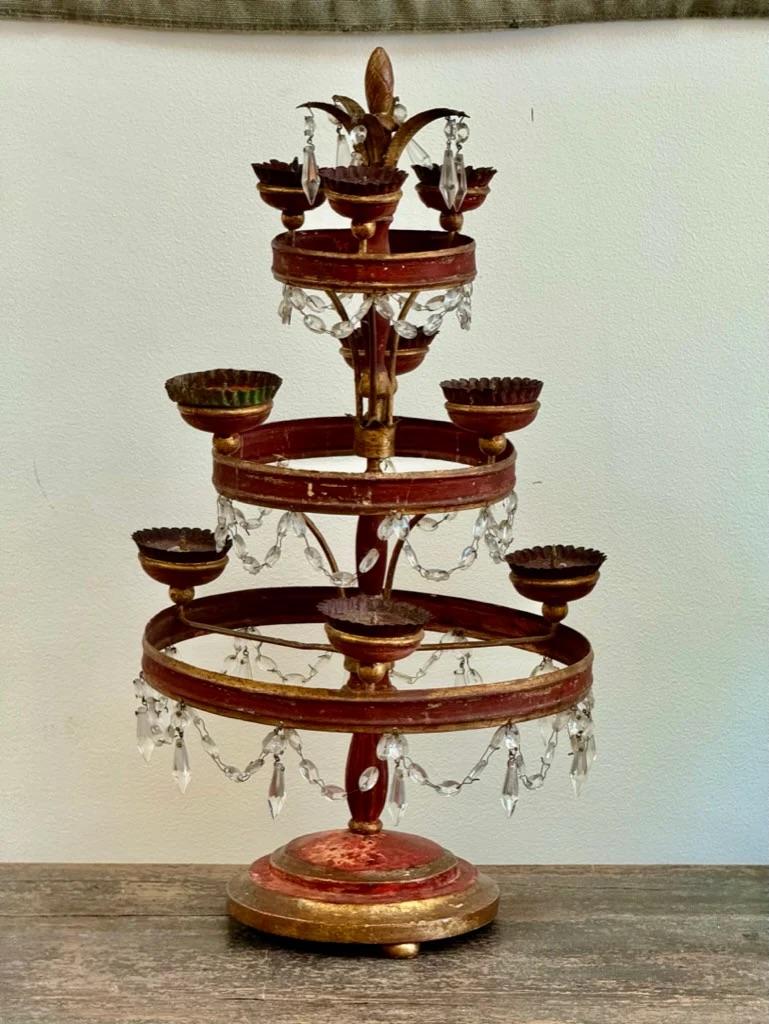 Late 18th-early 19th Century Italian tole and crystal girandole or table chandelier, holding 9 candles, the charming red three-tiered table chandelier having draping hand-cut crystals.  22.25” h. x 11.25” diam. 

