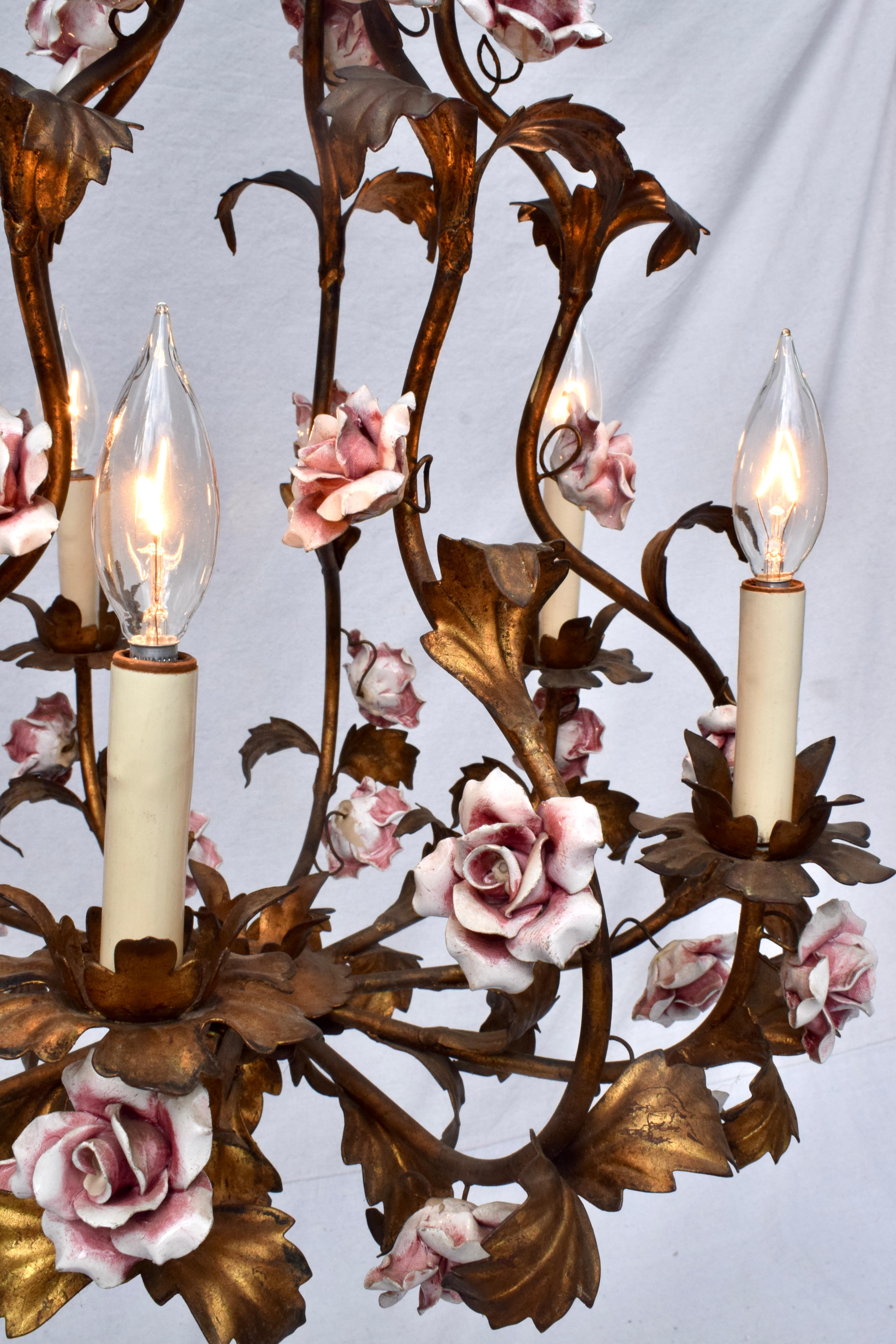 An exquisite patinated bronzed antique gold gilt Tole chandelier with 32 intricately hand crafted pink porcelain roses. Six arms & lights, Italian mid 20th Century with newer hardwiring.