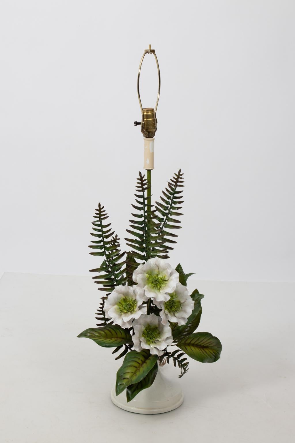 Tole table lamp with large scale fern foliage and white flower detail, circa 1950s. Please note of minor chips and losses to paint as seen on the leaves and base. Made in Italy with tag. Shade not included.