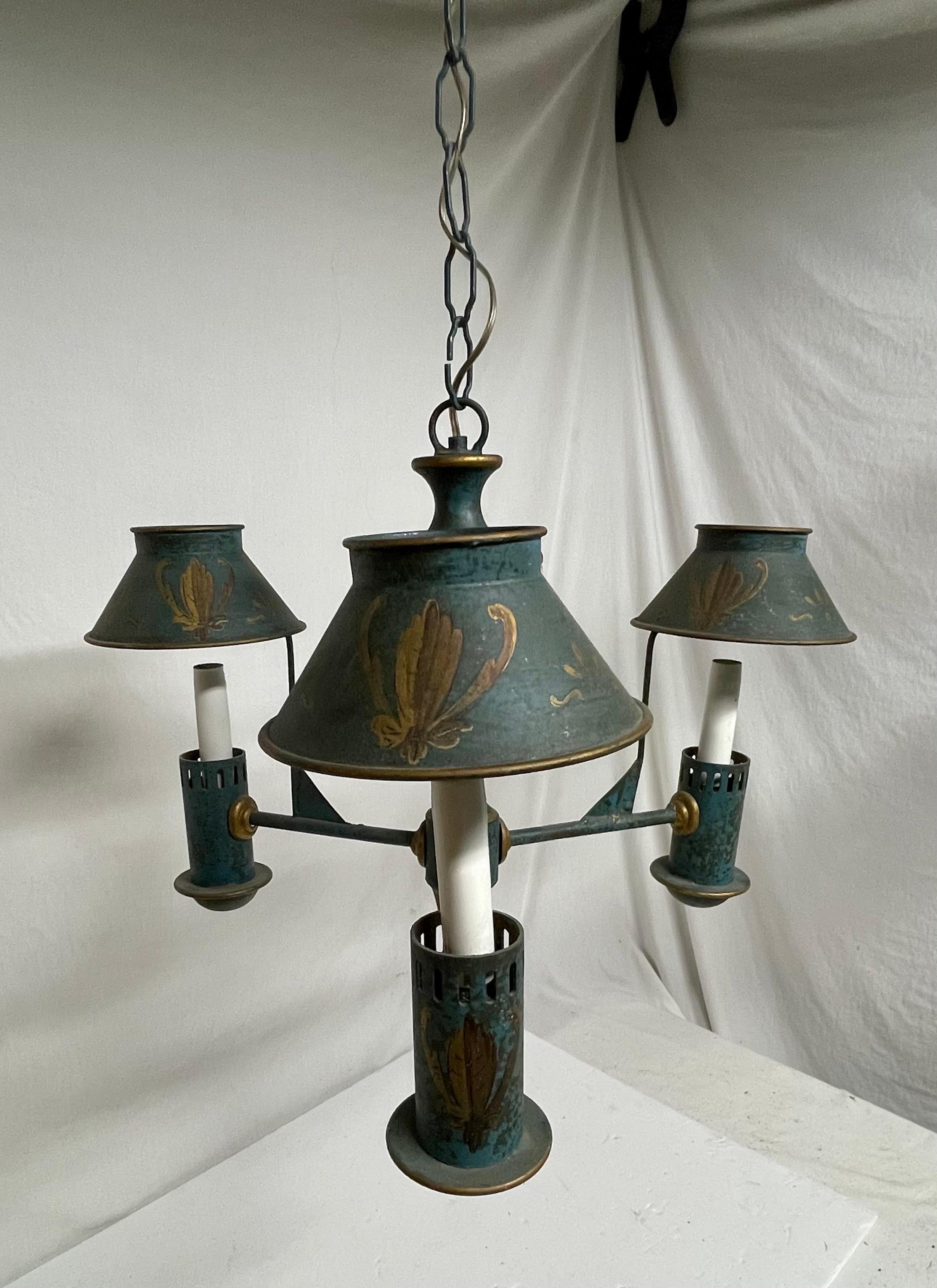 Tole painted three light chandelier. Hand painted metal frame with three metal attached shades. 35