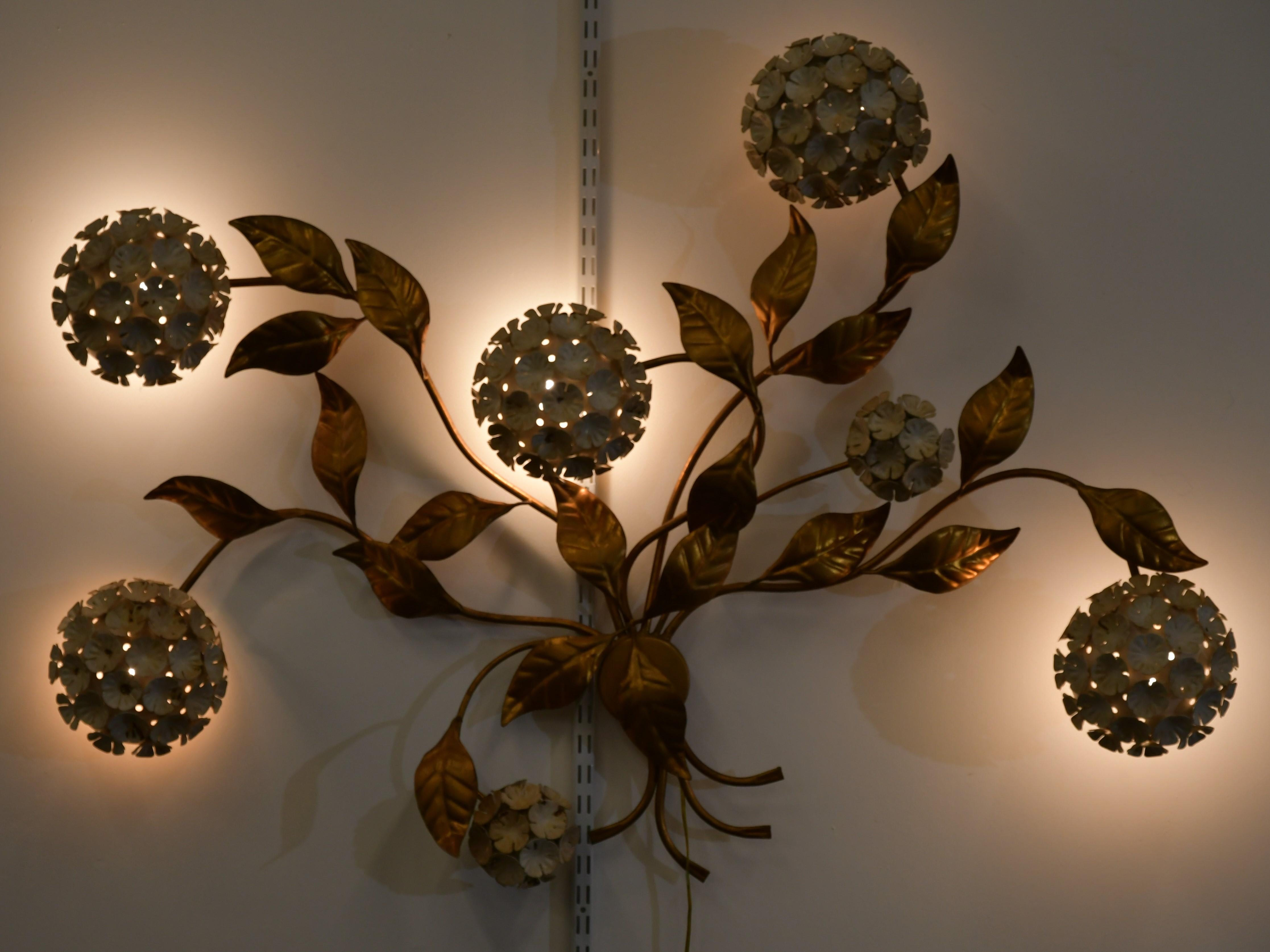 A whimsical Dorthy Draper style tole hydrangea wall sculpture. This large shabby chic wall sculpture has fixtures that light up when plugged into the wall. It would make a great statement piece in a beach house or farmhouse setting, etc. Some wear