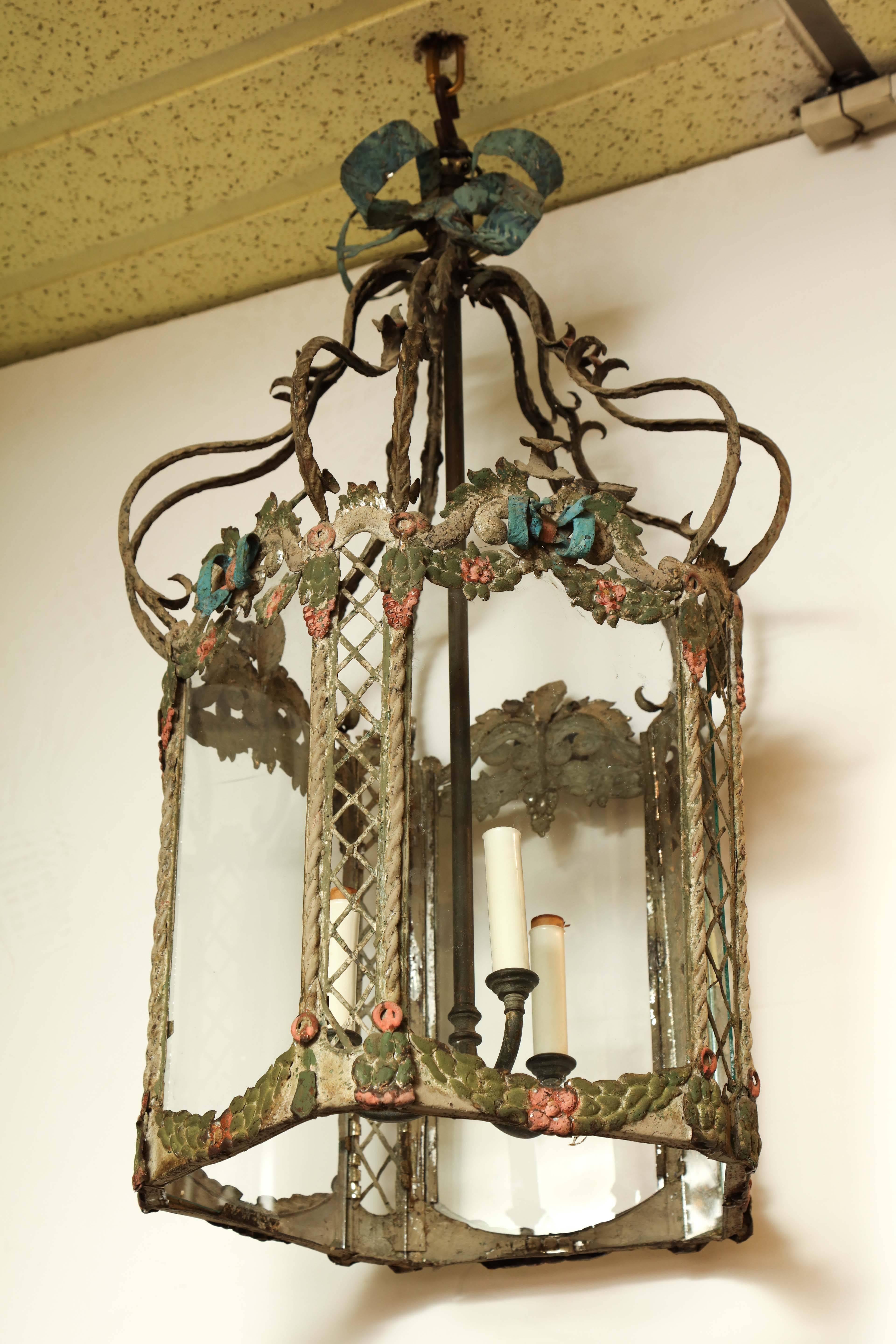 Unusual polychrome Italian tole peinte hall lantern with bowknots, flowers and door.