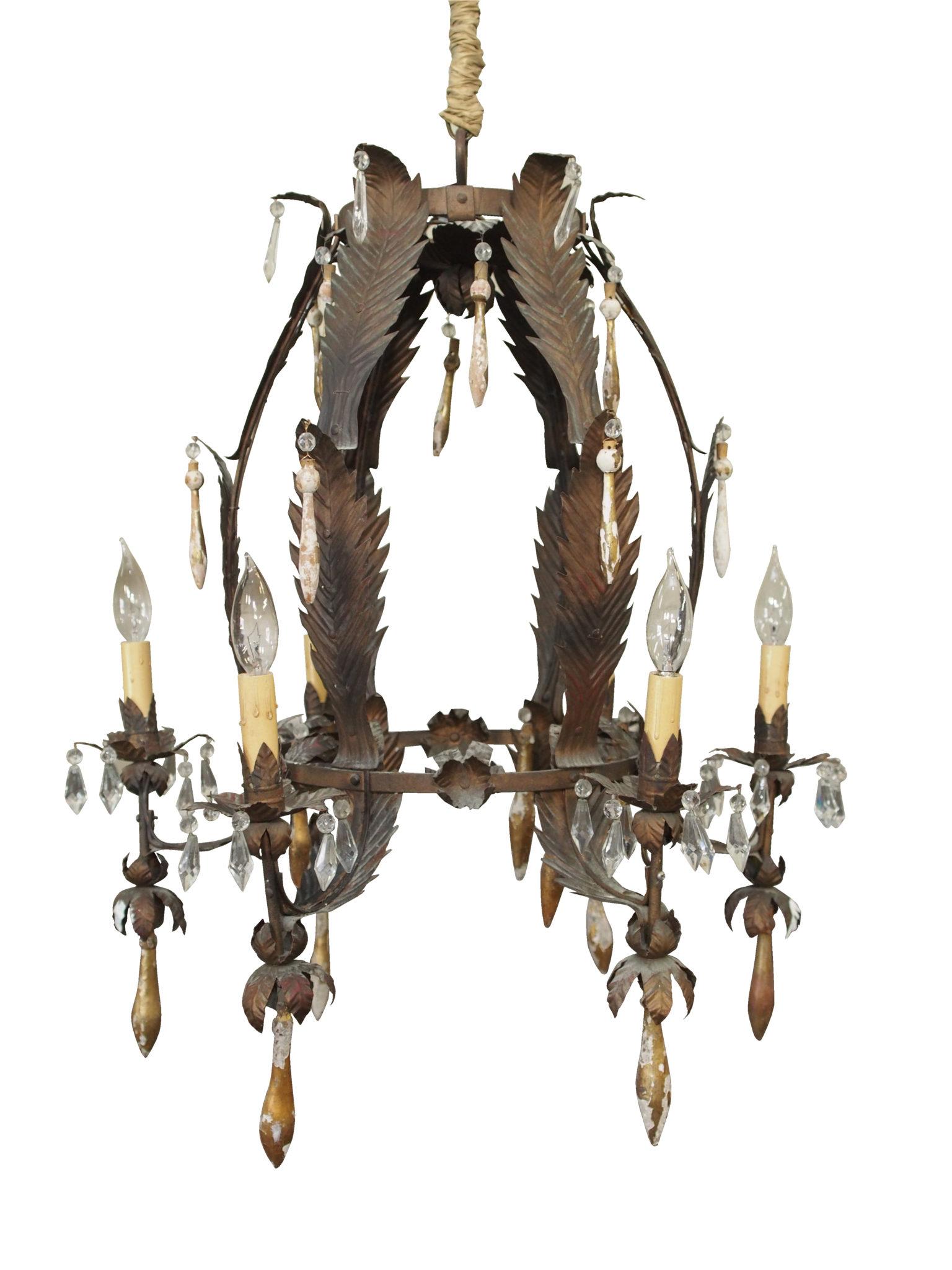 Italian tole leaf chandelier with gilded tassels and crystals.

Purchased in the South of France, this unique 6-arm chandelier is a leaf form in metal with detail in elements that surround each bobeche and arm.