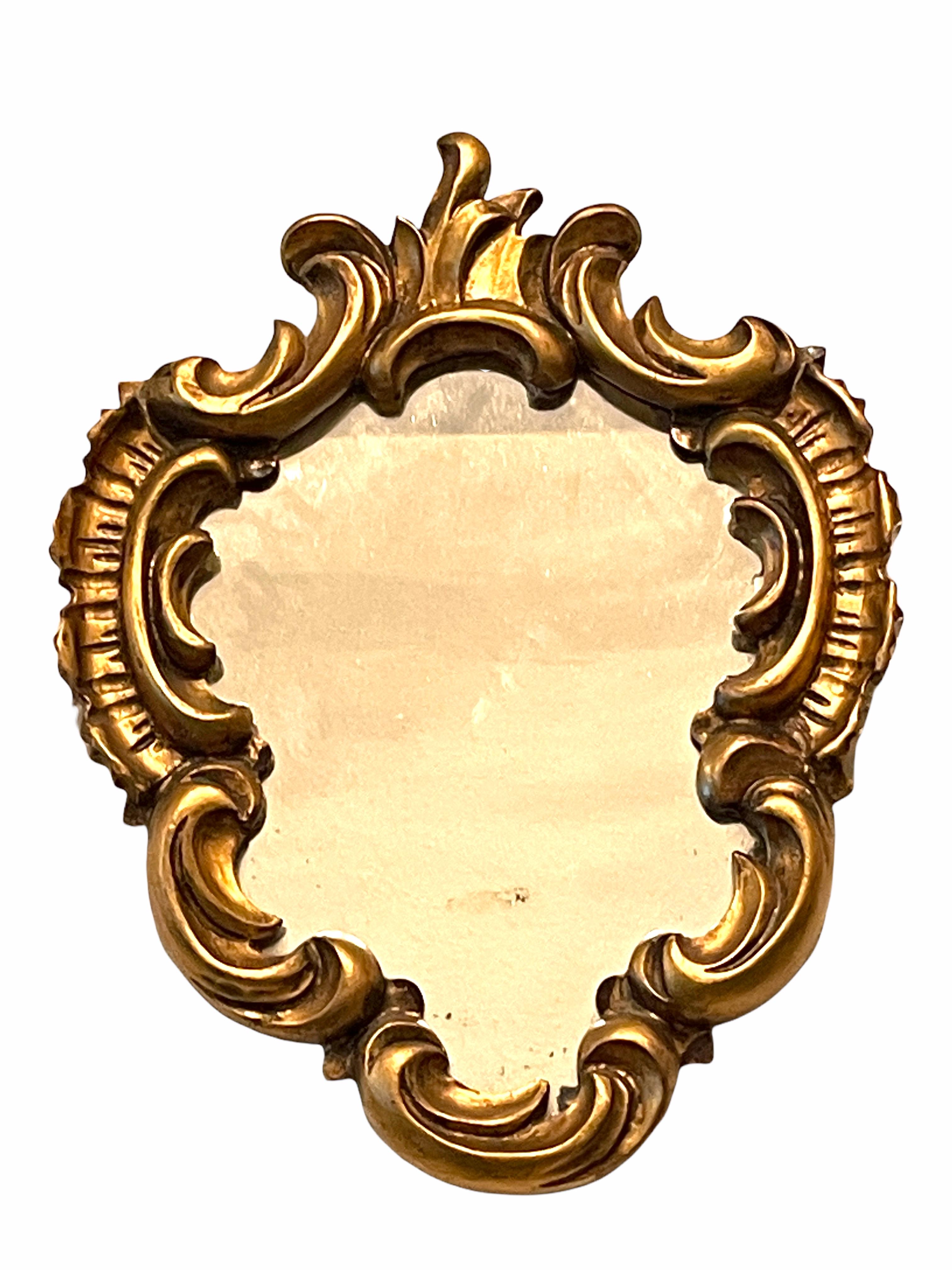 A gorgeous toleware mirror. Made of gilt wood and composition. A nice addition to any room.
