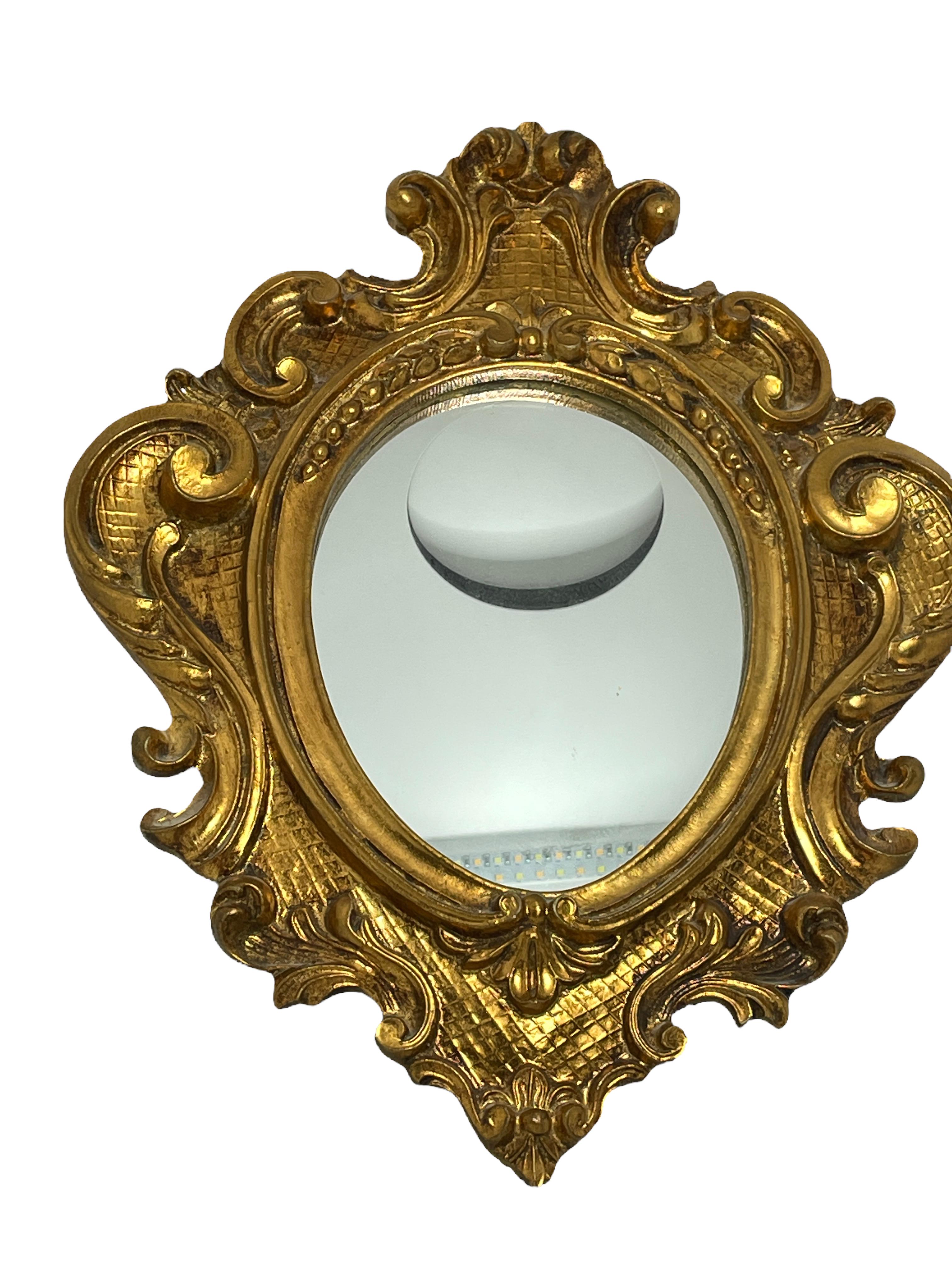 A gorgeous toleware mirror. Made of gilt wood and composition. A nice addition to any room. Mirror itself is approx. 7.5